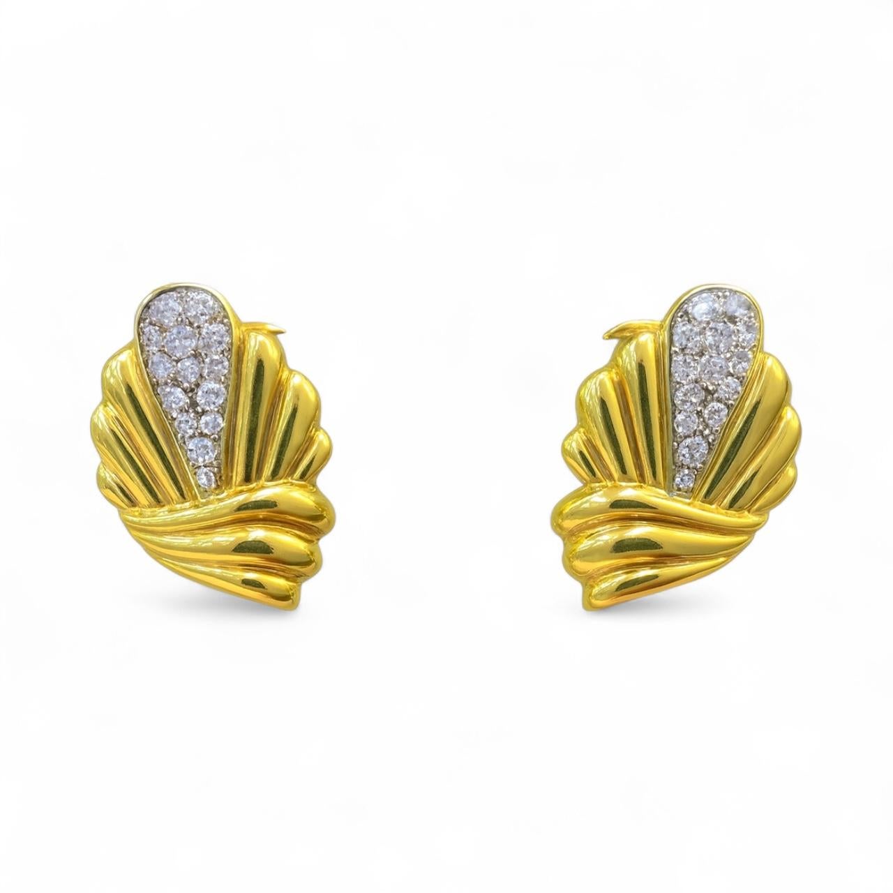 A striking pair of vintage earrings crafted in 18K yellow gold, designed in an elegant fan motif that captures the bold geometry and polished curves characteristic of mid-century glamour. Each earring features a sleek, sculptural form accented with