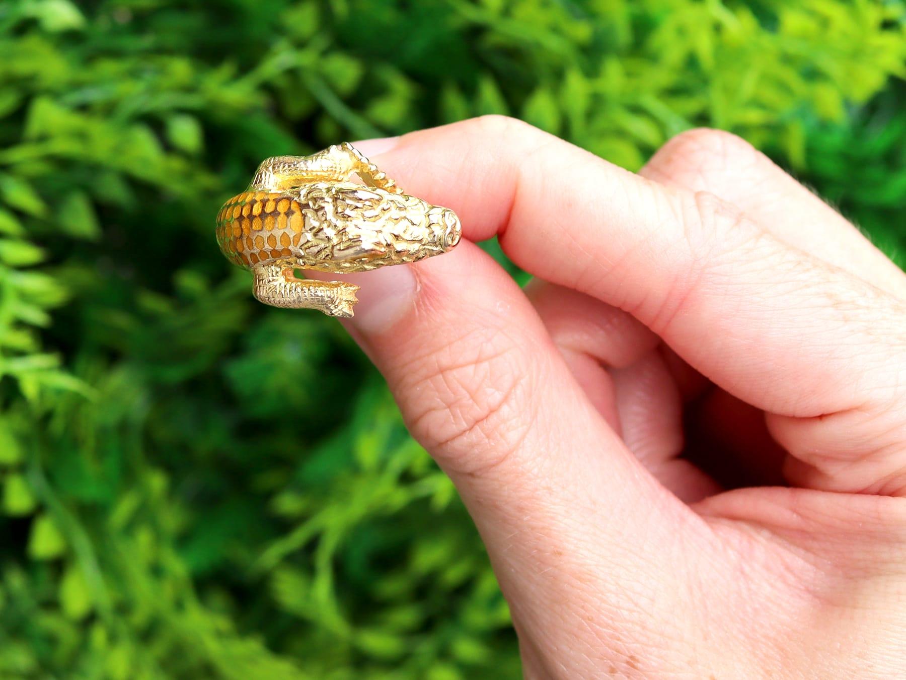 A fine and impressive vintage 18 karat yellow gold and plique-à-jour crocodile ring; part of our diverse vintage jewellery collections.

This fine and impressive vintage ring has been crafted in 18k yellow gold.

The ring has been modelled in the