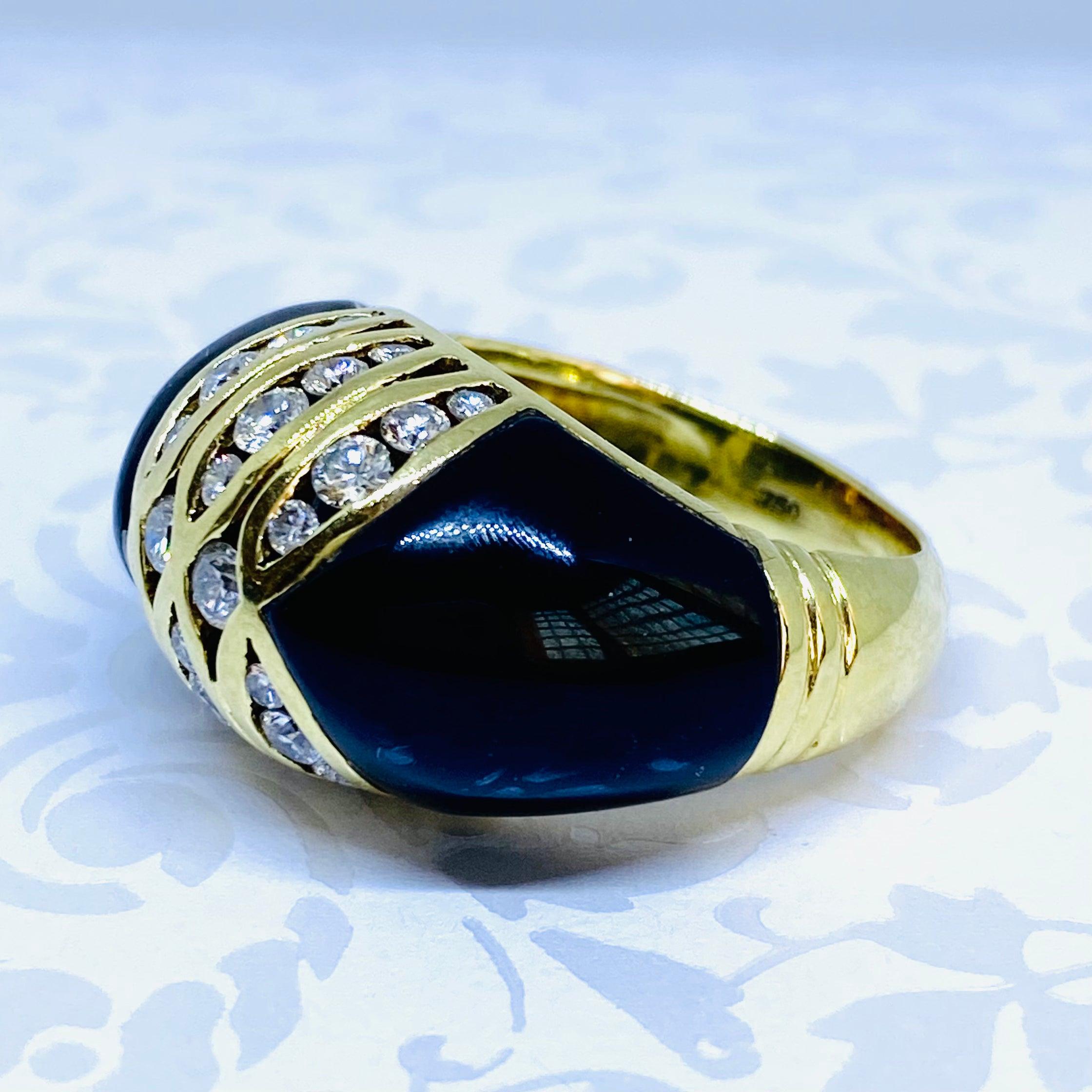 Crafted in 18K yellow gold, the ring features a dome design with channel set diamonds in the center, supported by custom cut black onyx shoulders.
26 round brilliant cut diamonds: 1.00ctw. Color: G-H, Clarity: VS1-VS2
Measurements:
Front: 14 mm H x
