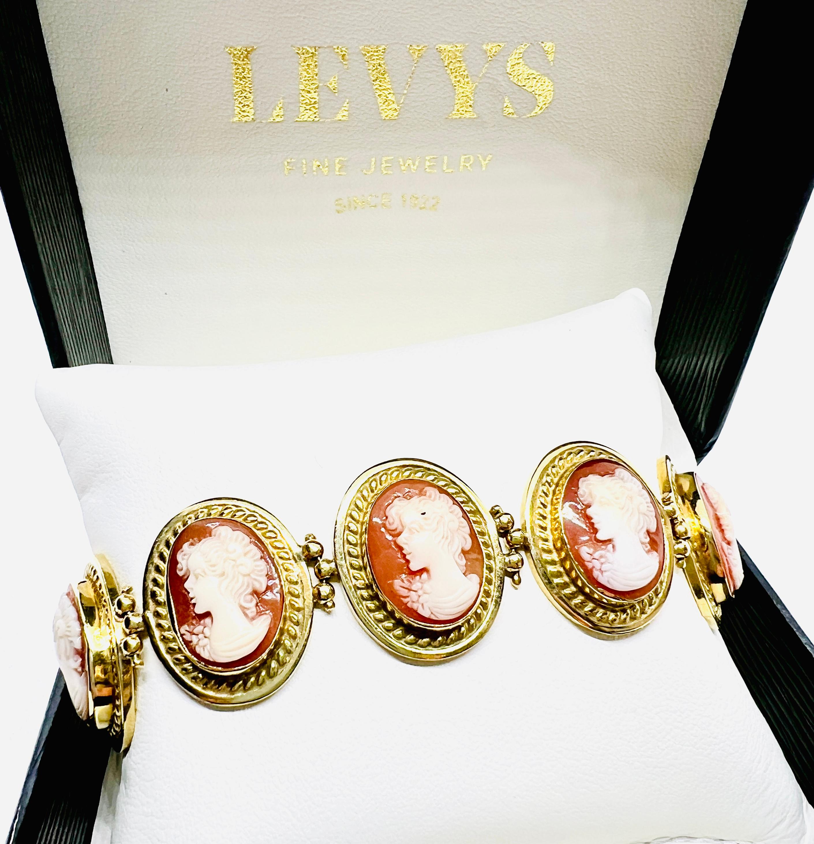 Absolutely beautiful 18K yellow Gold Cameo Bracelet. This piece features nine oval carved shell cameos. Each cameo measures one inch by three quarter inch. The bracelet is seven and a half inches long and it weighs 49.0 grams. This is a true vintage