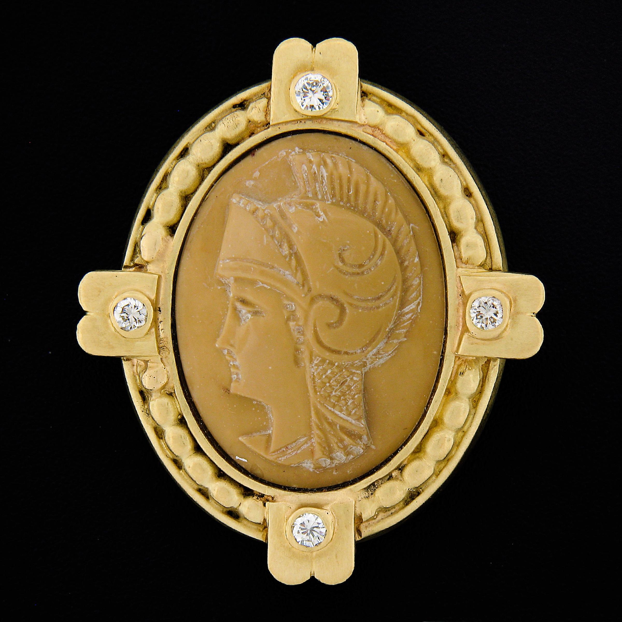 Here we have a gorgeous and very well made cameo and diamond brooch crafted in solid 18k yellow gold and features an oval shaped beige hardstone that is beautifully carved with a detailed trojan wearing his helmet. The solidly made frame has nice