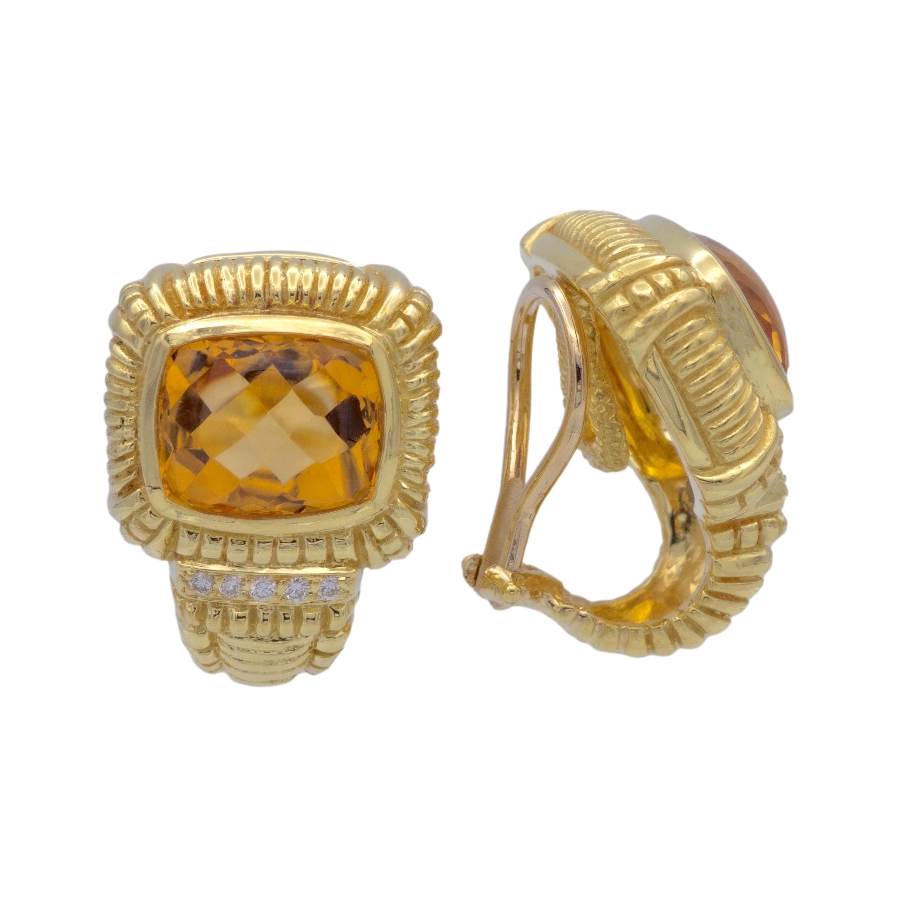 Pair of 18K Yellow Gold clip earrings finely crafted in 18 karat yellow gold featuring two elongated cushion shape center citrine gemstones set inside bezel frames surrounded by ribbed edges accented by 10 round brilliant cut diamonds. weighing 0.08