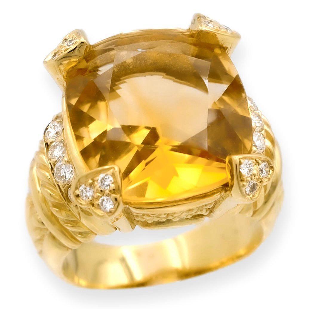 Vintage ring finely crafted in 18 karat yellow gold featuring a large faceted cushion shape citrine center weighing 9-10 carats approximately set in heart shaped prongs with 12 round brilliant cut diamonds plus an additional 10 diamonds on the sides