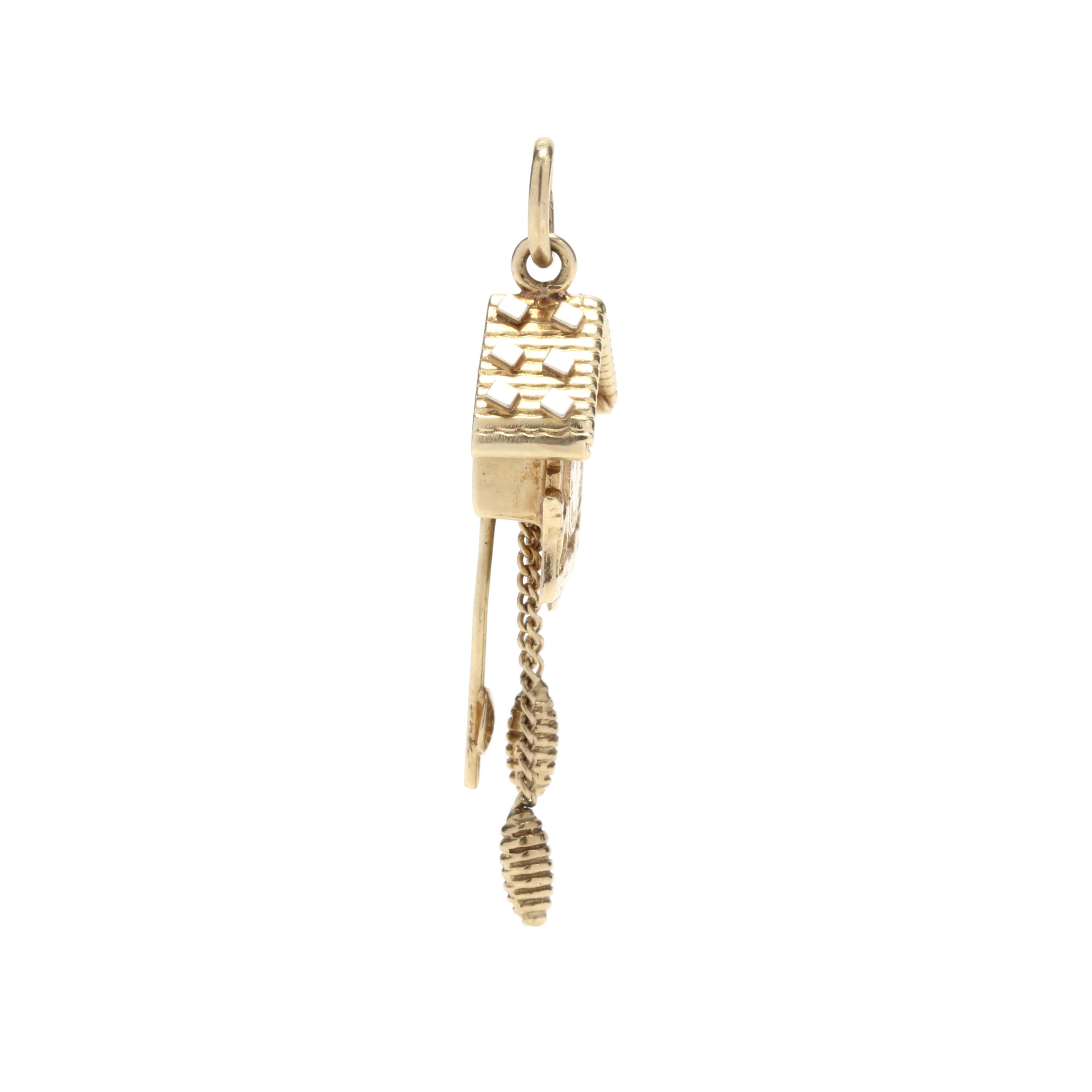 A vintage 18 karat yellow gold coo-coo clock charm. This charm features a birdhouse clock design with a tiny bird motif popping out of a window up top, two dangling pine cones and a swaying ticker.



Length: 1.5 in.



Width: 1/2 in.



Weight: 3.7