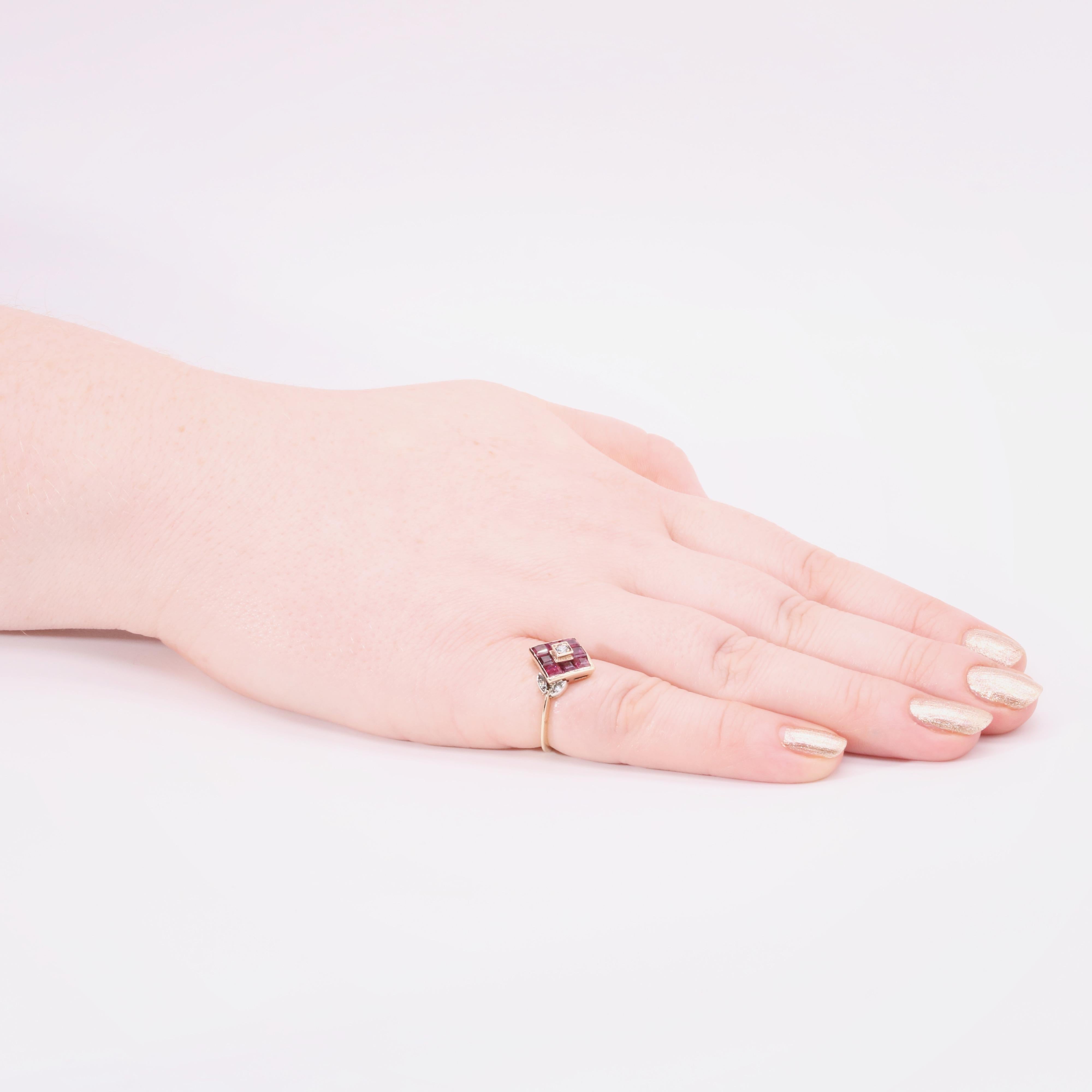 A vintage ruby, diamond, and yellow gold ring, comprising one round brilliant cut diamond, four small round cut diamonds, and eight square cut rubies, set in 18 karat yellow gold, to an 18 karat yellow gold band. 

A striking ring, set with