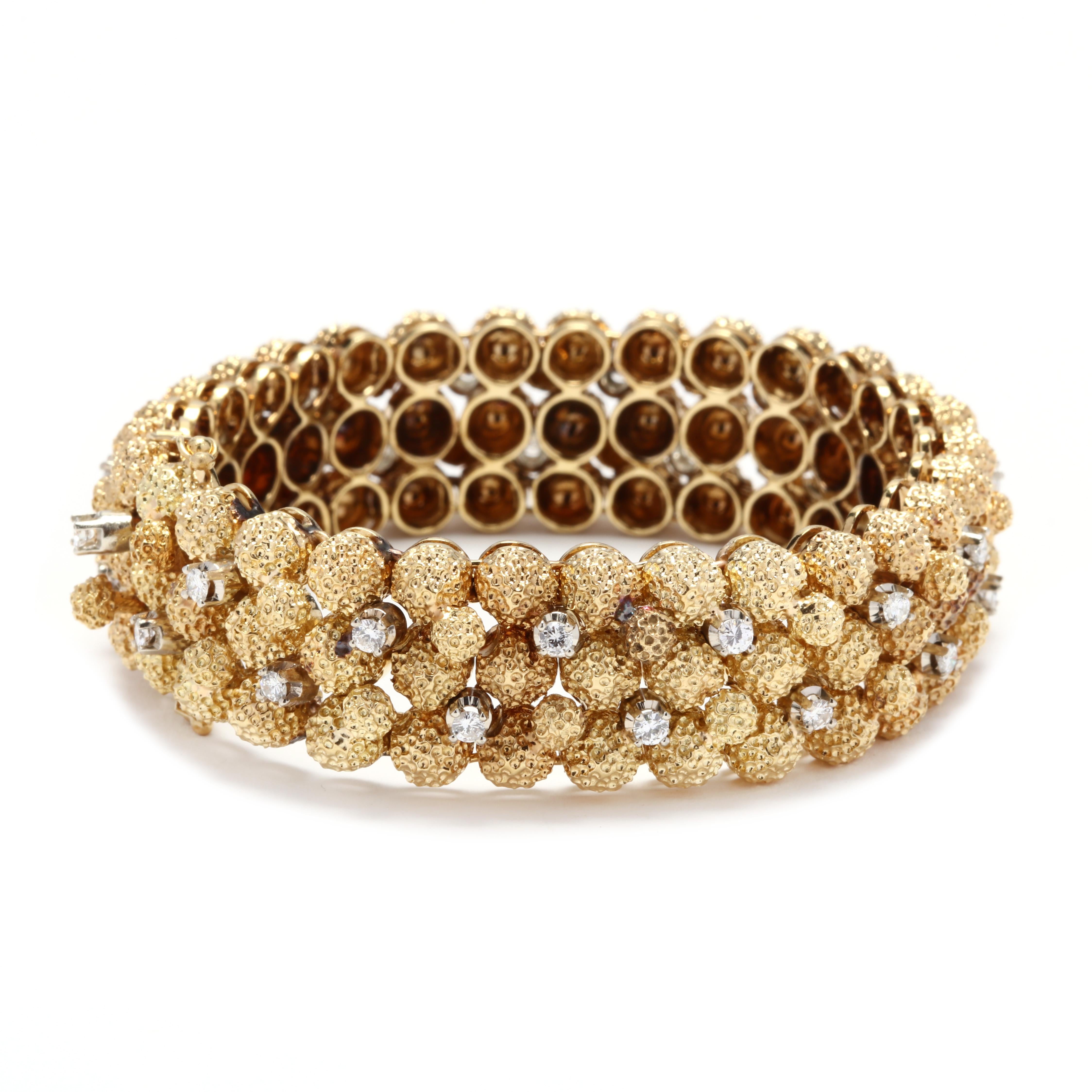 A vintage 18 karat yellow gold and diamond bracelet. This bracelet features stippled, dome links with prong set, round full cut diamond accents weighing approximately 1.3 total carats and a box clasp. This is your statement bracelet!

Stones:
-