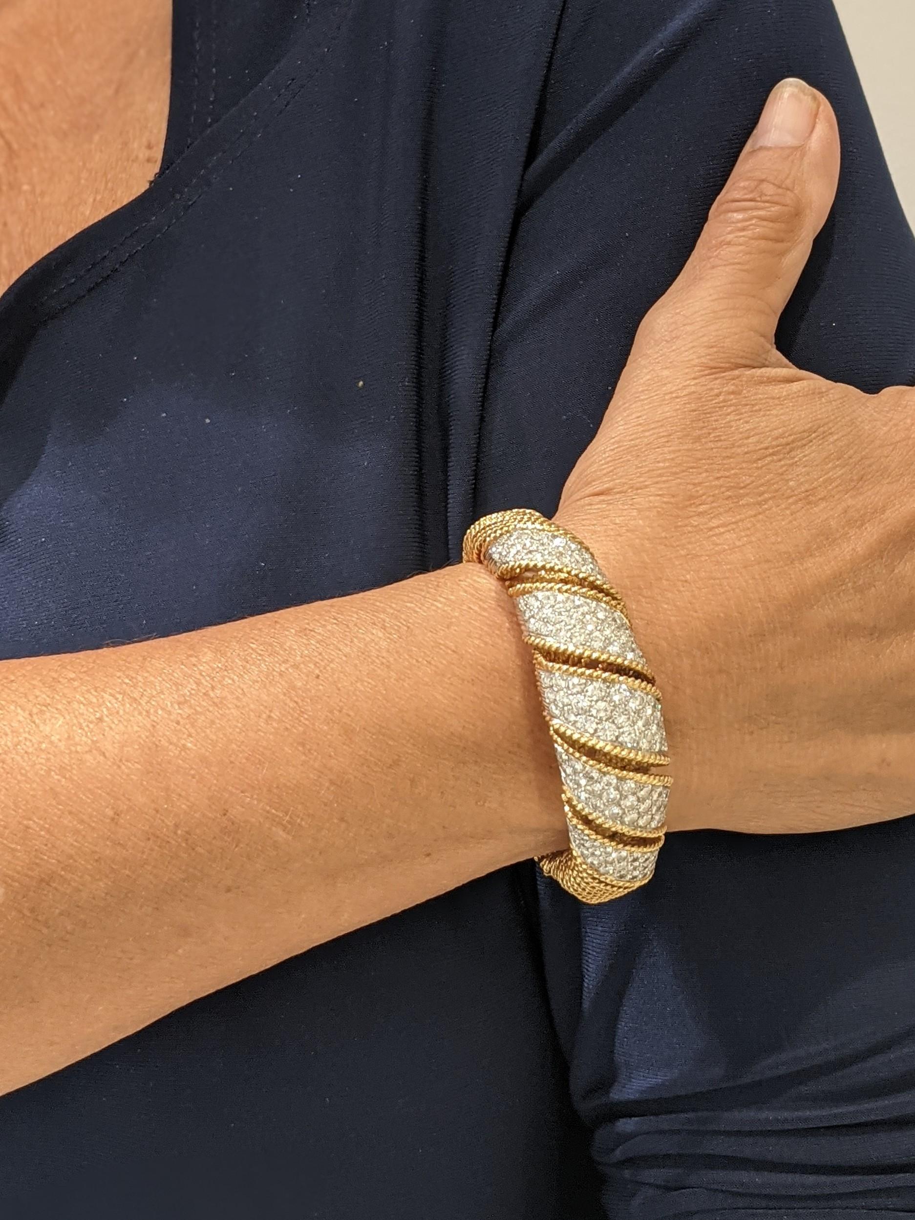 Vintage 18k Yellow gold woven bracelet with 8.85 carats of diamond and 66.5gram. The bracelet has 141 round diamonds weighing approximately 8.85 carats with a color of G/H and a clarity of VS2. The bracelet measures a 6. The clasp is an open box