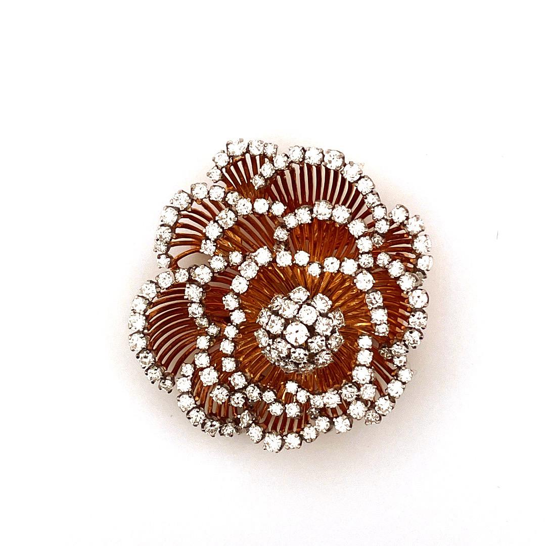 This vintage brooch is a true masterpiece,
weighing 40.4g  crafted from 18K yellow gold and
featuring a stunning 12.0TCW plus diamonds flower design.
The intricate details of the petals showcase the high-quality craftsmanship of this