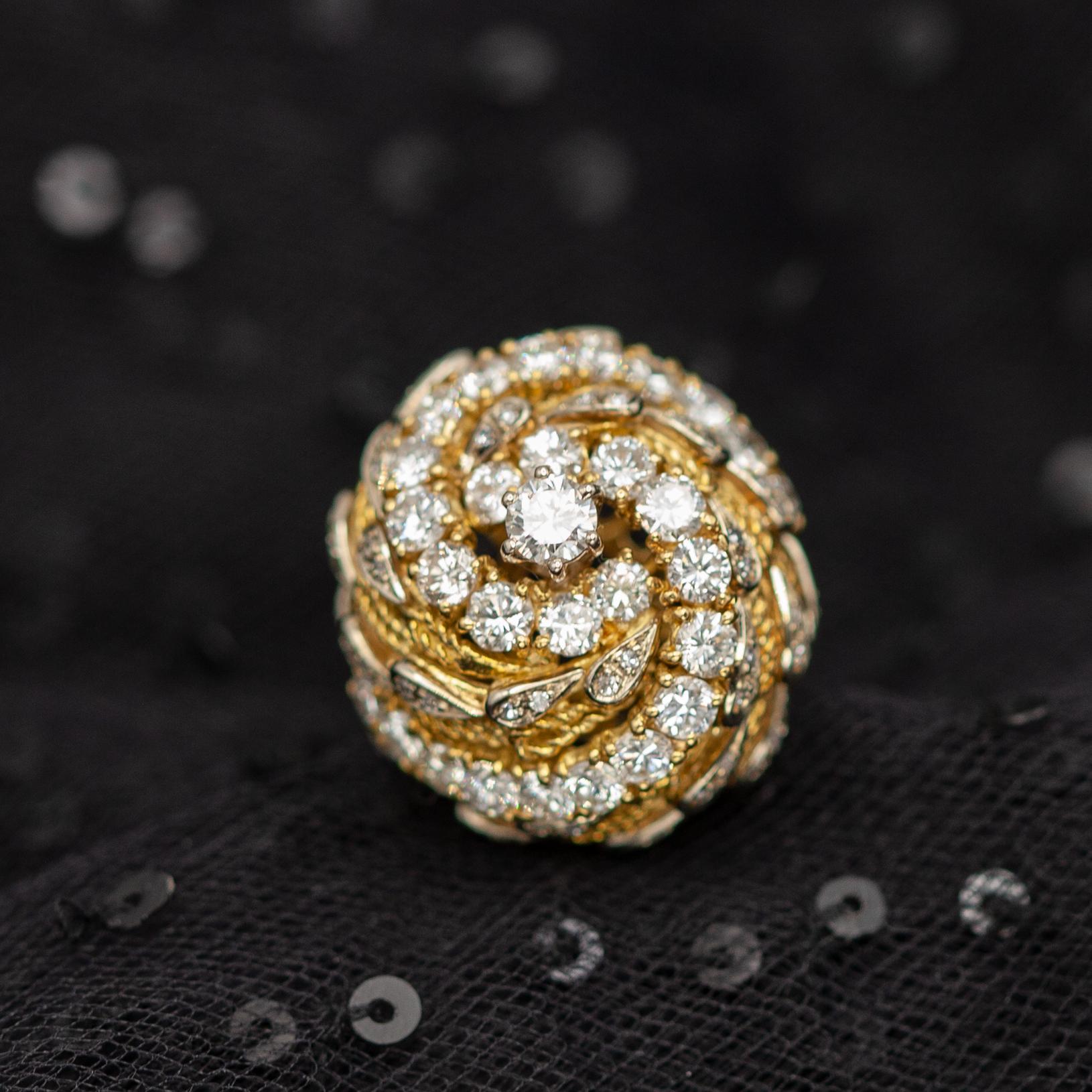 An eye-catching cocktail ring crafted in rich 18K yellow gold, designed in a bold domed swirl motif. The intricate spiral is adorned with 85 brilliant-cut diamonds approximate 3.00 carats in G color VS clarity, artfully arranged in graduated tiers