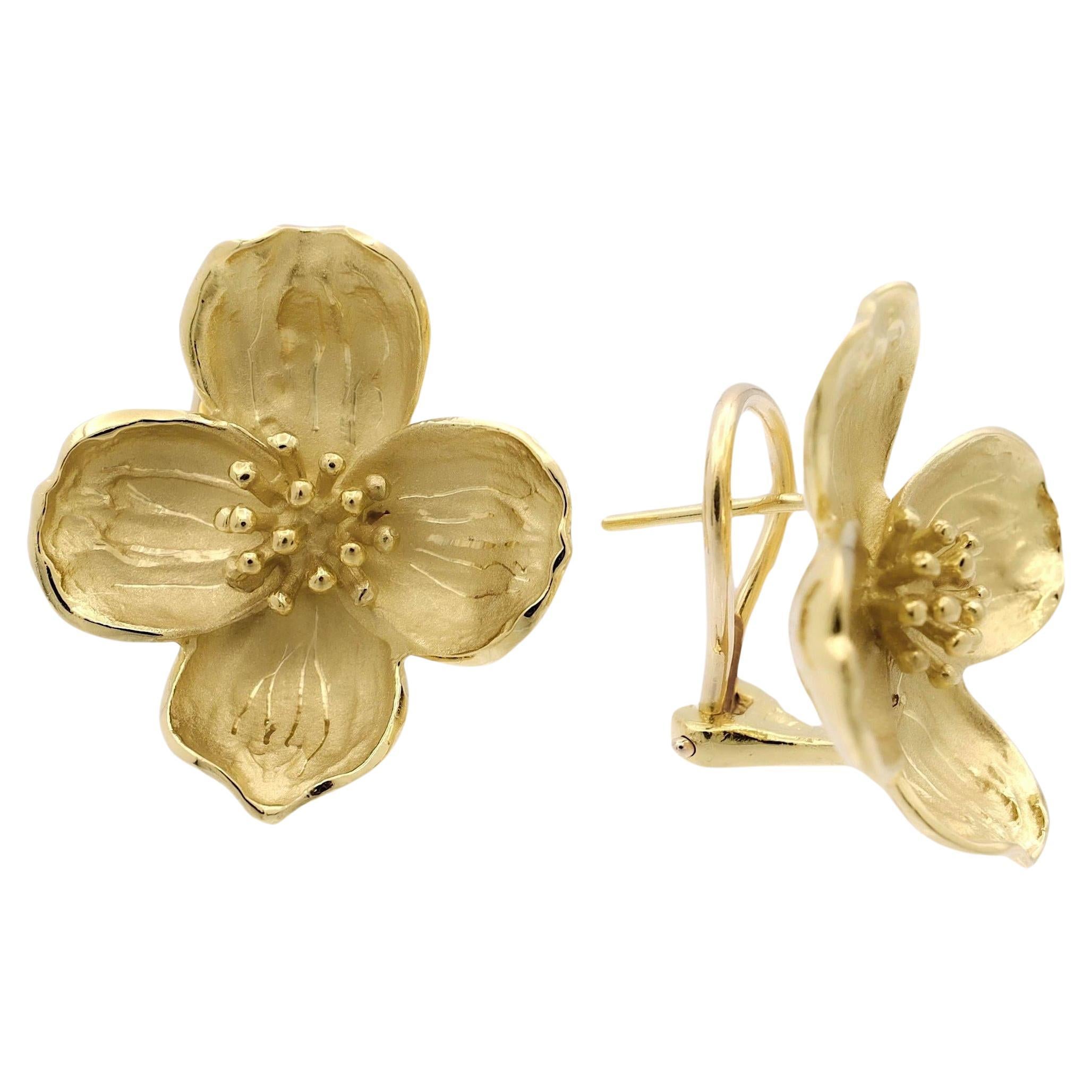Vintage Dogwood Floral earrings, meticulously crafted in lustrous 18 karat yellow gold. These exquisite earrings showcase the delicate beauty of dogwood flowers, capturing their essence in intricate detailing. The interior boasts a satin finish,