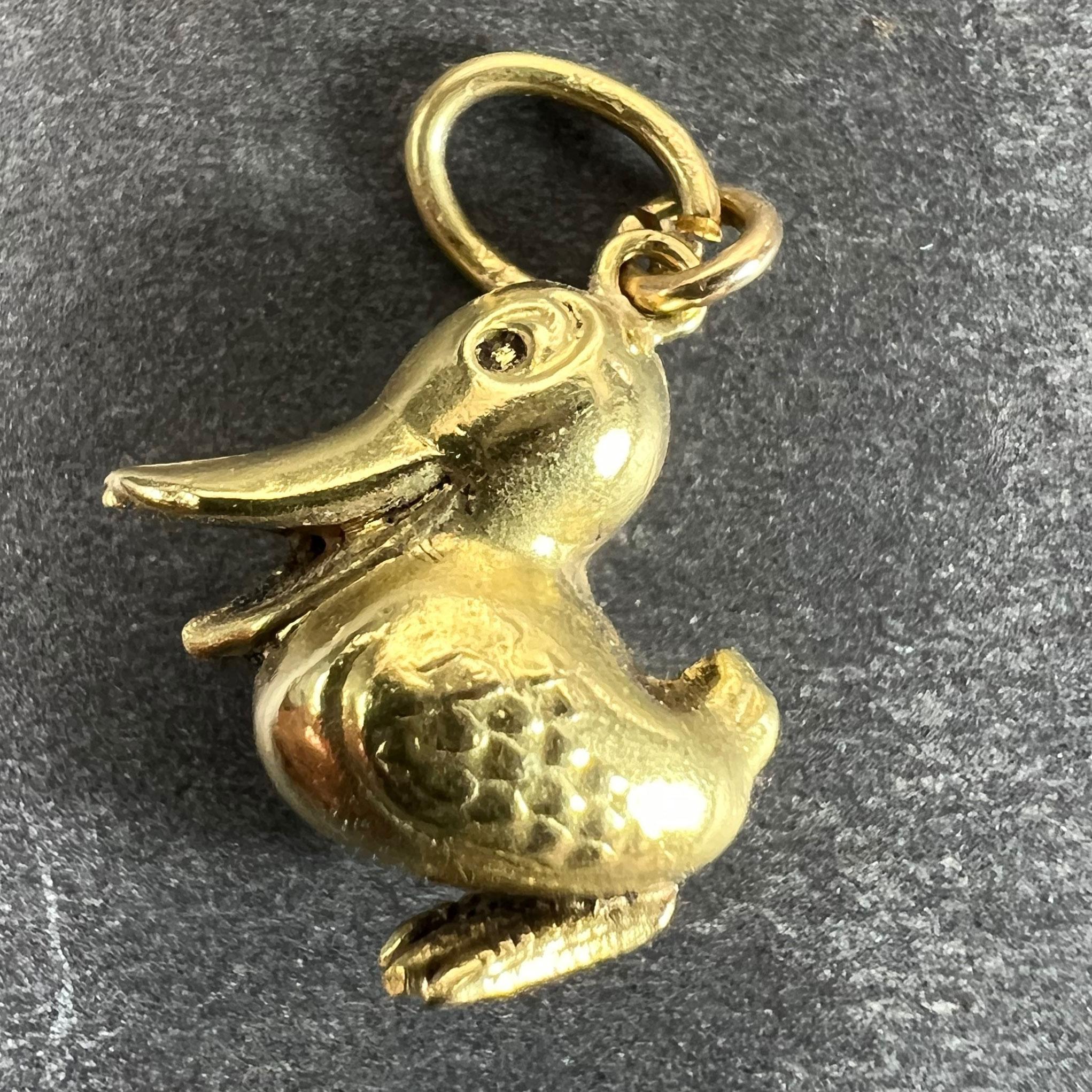 A vintage 18 karat (18K) yellow gold charm pendant designed as a bird or duck. Unmarked but tested for 18 karat gold.

Dimensions: 1.6 x 1.3 x 0.67 cm (not including pendant bail)
Weight: 1.23 grams
(Chain not included)