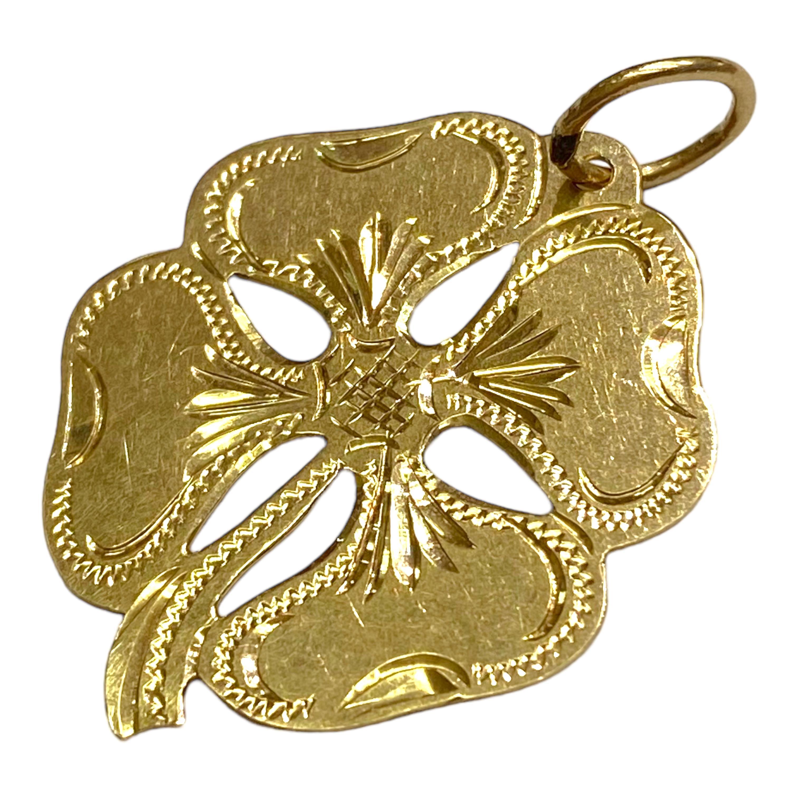 Vintage 18K yellow gold hand engraved four leaf clover charm pendant.
Measurements:  33 mm H (including bail) x 24 mm W
Weight: 2.3 grams
Marked: 18K G.M. (maker's mark)