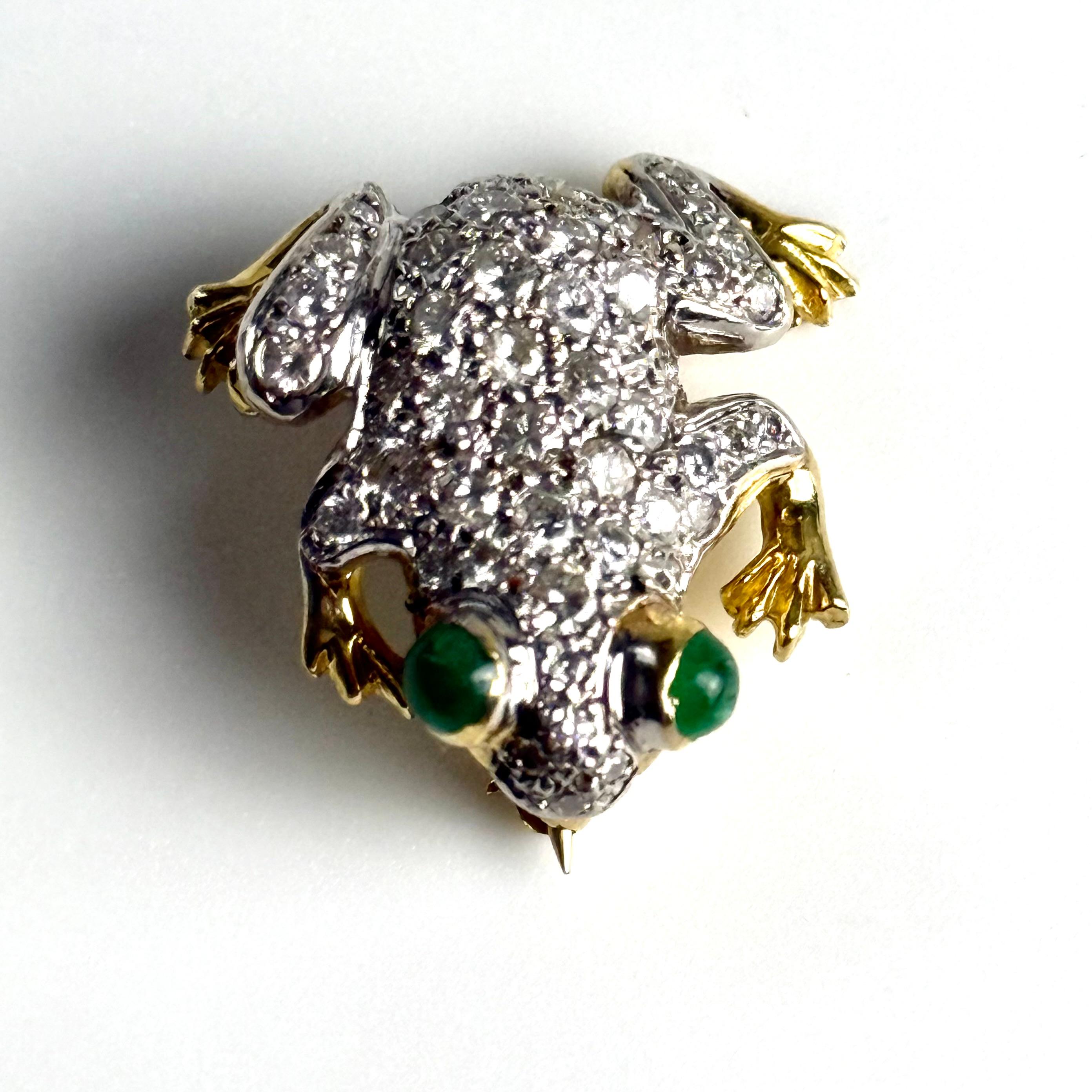 A Whimsical Emblem of Charm and Luxury
Invite a dash of playful sophistication into your collection with this Vintage 18K Yellow Gold Frog Brooch, gracefully set with approximately 0.95 carats of diamonds and accented by gleaming emeralds. Its