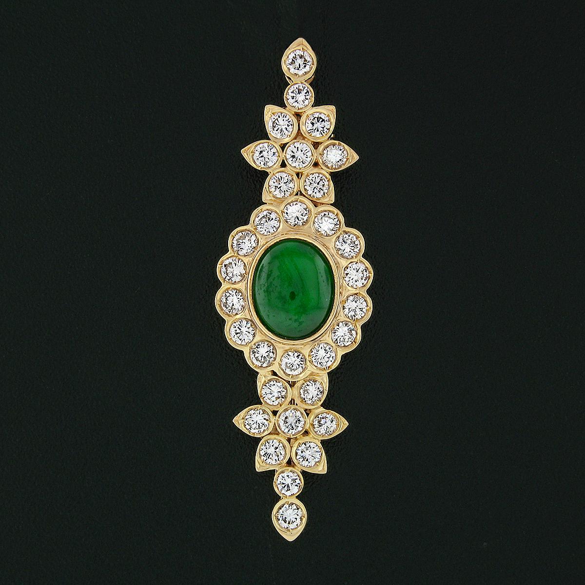 This magnificent vintage brooch is solidly crafted from 18k yellow gold and features a stunning, GIA certified, natural jade stone neatly bezel set at the center of the pin. The natural oval cabochon jade is a very fine quality stone and reflects