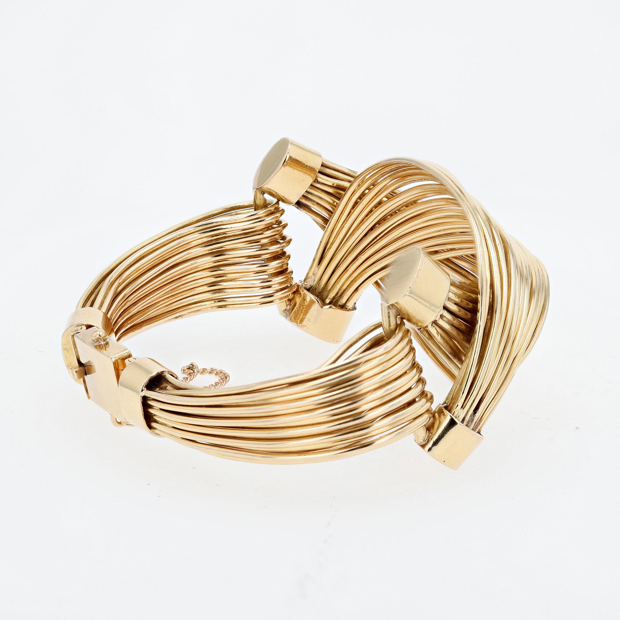 Vintage 18 Yellow Gold Post War (ca 1950s) handmade double hinged sculptural cuff with 18 rows
of 18YG wire wrap bracelet. Locking clasp safety chain.
