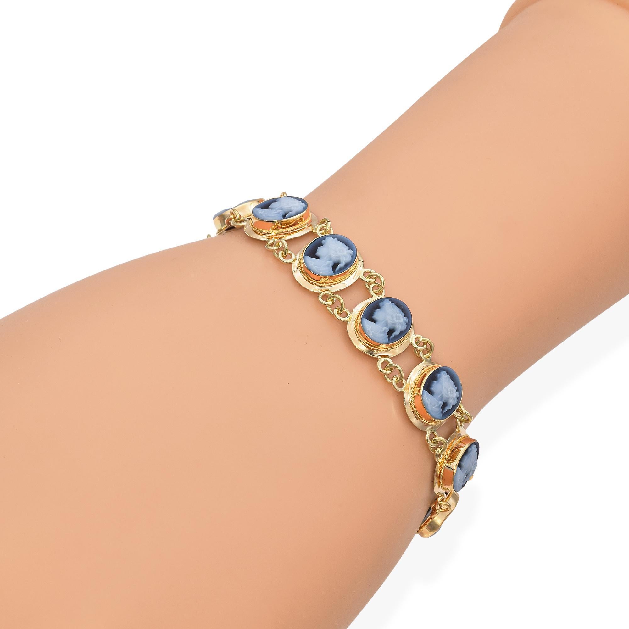 This elegant bracelet captivates with its intricate design and classic charm. It features a series of oval blue cameos, each depicting a delicate profile, set in polished gold frames. The cameos are linked by small gold chains, creating a seamless