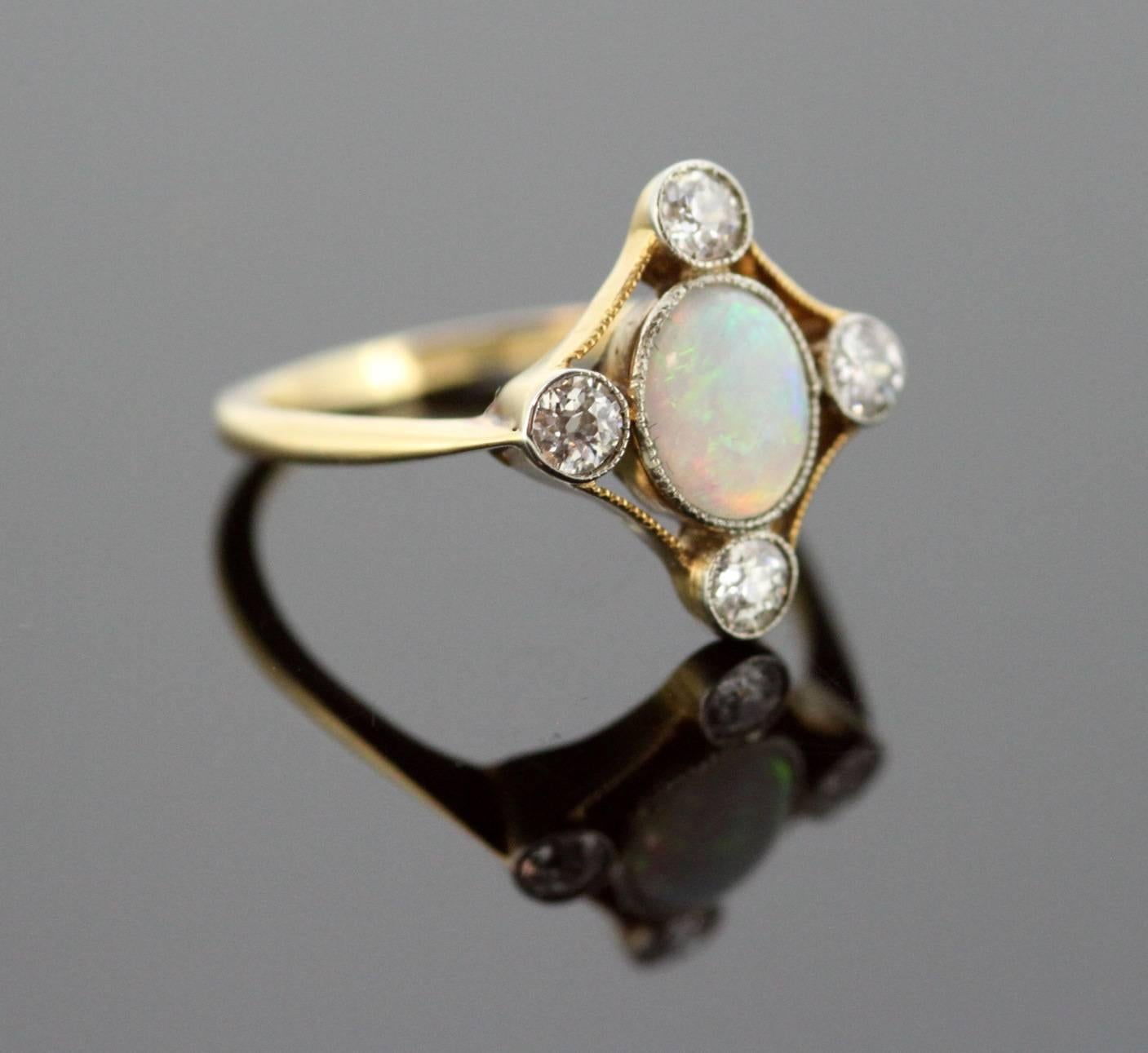 Vintage 18K yellow gold ladies ring with opal (1 CT) and diamonds (0.40 CT Total) 
Hallmarked 18K 
Circa.1970s 

Dimensions - 
Ring Size : 2.3 x 2.1 x 1.5 cm 
Finger Size : (UK) = O (US) = 7 1/2 (EU) = 55 1/4 
Weight : 3 grams total 

Opal - 
Cut :