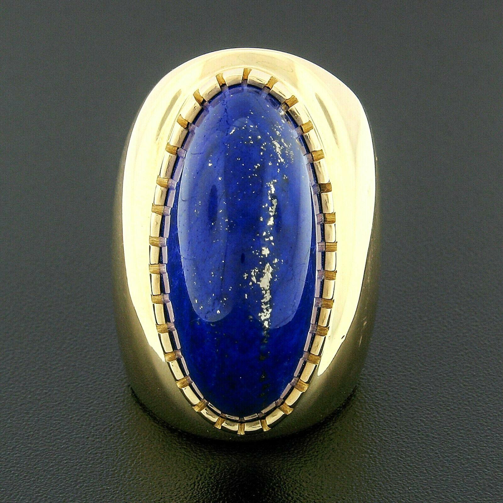 OUT of this WORLD, a bold and large statement cocktail ring crafted in solid 18k yellow gold and set with a truly breathtaking lapis lazuli, certified by GIA which guarantees that it is 100% natural and genuine stone. The stone is a magnificent oval