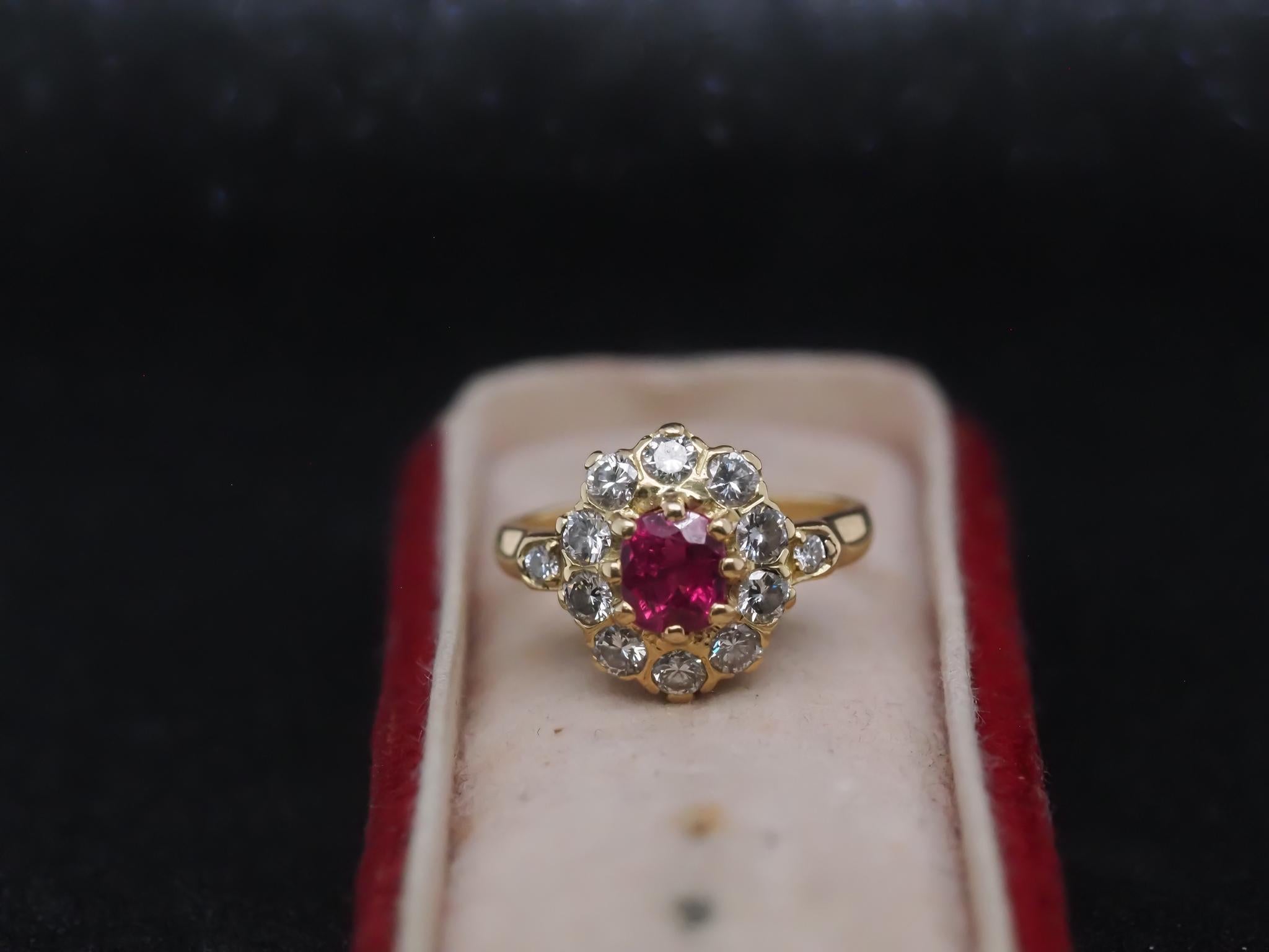 Year: 1980s

Item Details:
Ring Size: 4.75 (Sizable)
Metal Type: 18K Yellow Gold [Hallmarked, and Tested]
Weight: 4.5 grams

Diamond Details: Transitional Round, 1.00ct total weight, F-G Color, VS Clarity

Center Ruby Details : .60ct, Deep Red,