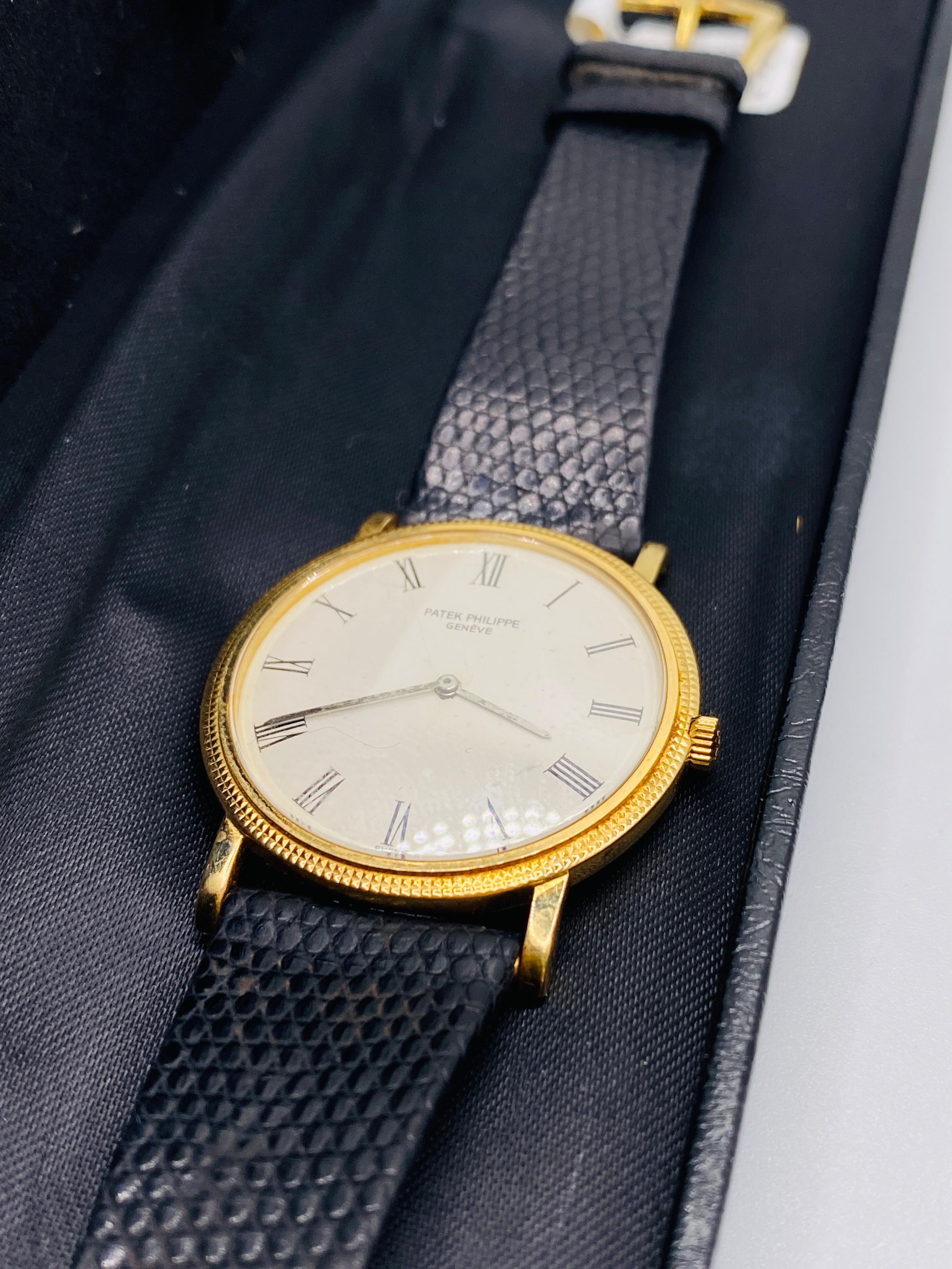 18k yellow gold Patek Phillipe Calatrava Swiss made ultra thin watch with mechanical movement with hobnail patterned case. Model 3520d. Water resistant to 25m. Serviced 4/18/22. Hallmarked with the Geneva seal. Includes original band, box and papers.