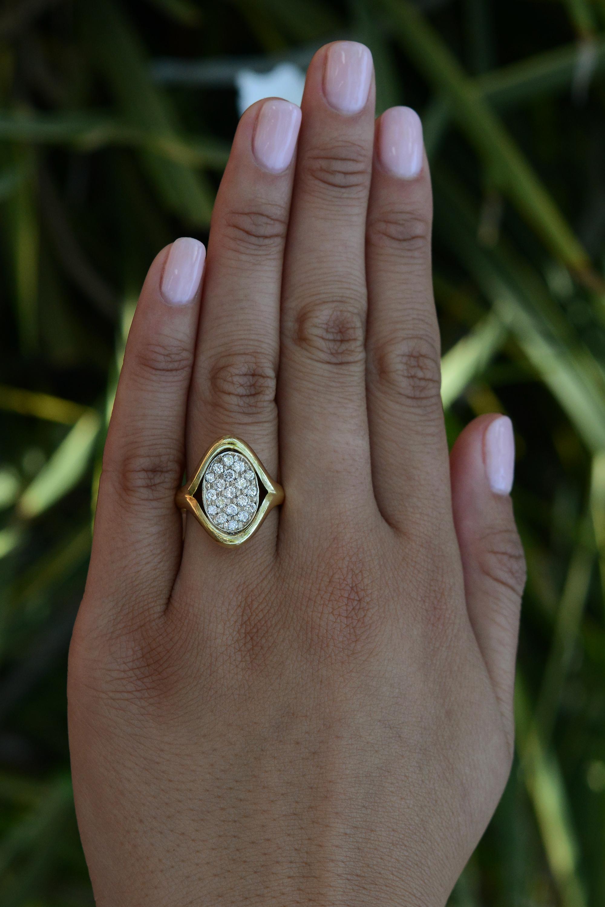 A cocktail ring is the perfect accessory for those who love vintage 1980s disco indulgence. This statement piece is crafted with a shimmering pavé setting with 3/4 carat of brilliant diamonds, set within an 18 karat yellow gold saddle setting. This