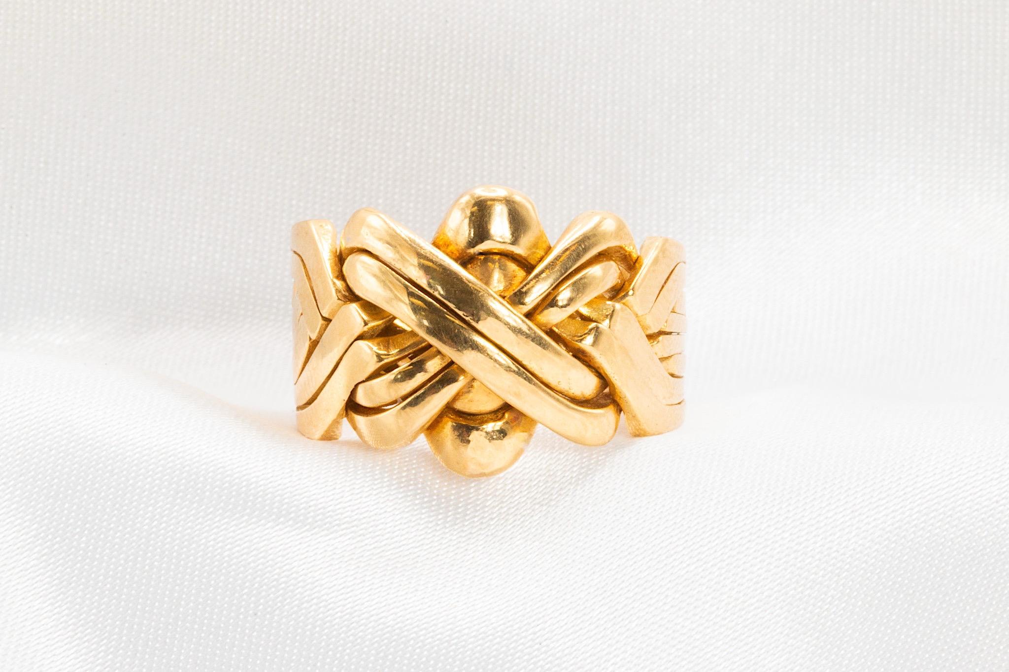 Vintage 18k Yellow Gold Puzzle Ring – Bold, Sculptural Design

Crafted in rich 18k yellow gold, this vintage puzzle ring makes a confident statement with its bold, interlocking design. The band tapers from 16.2 mm to 8.6 mm, offering both comfort