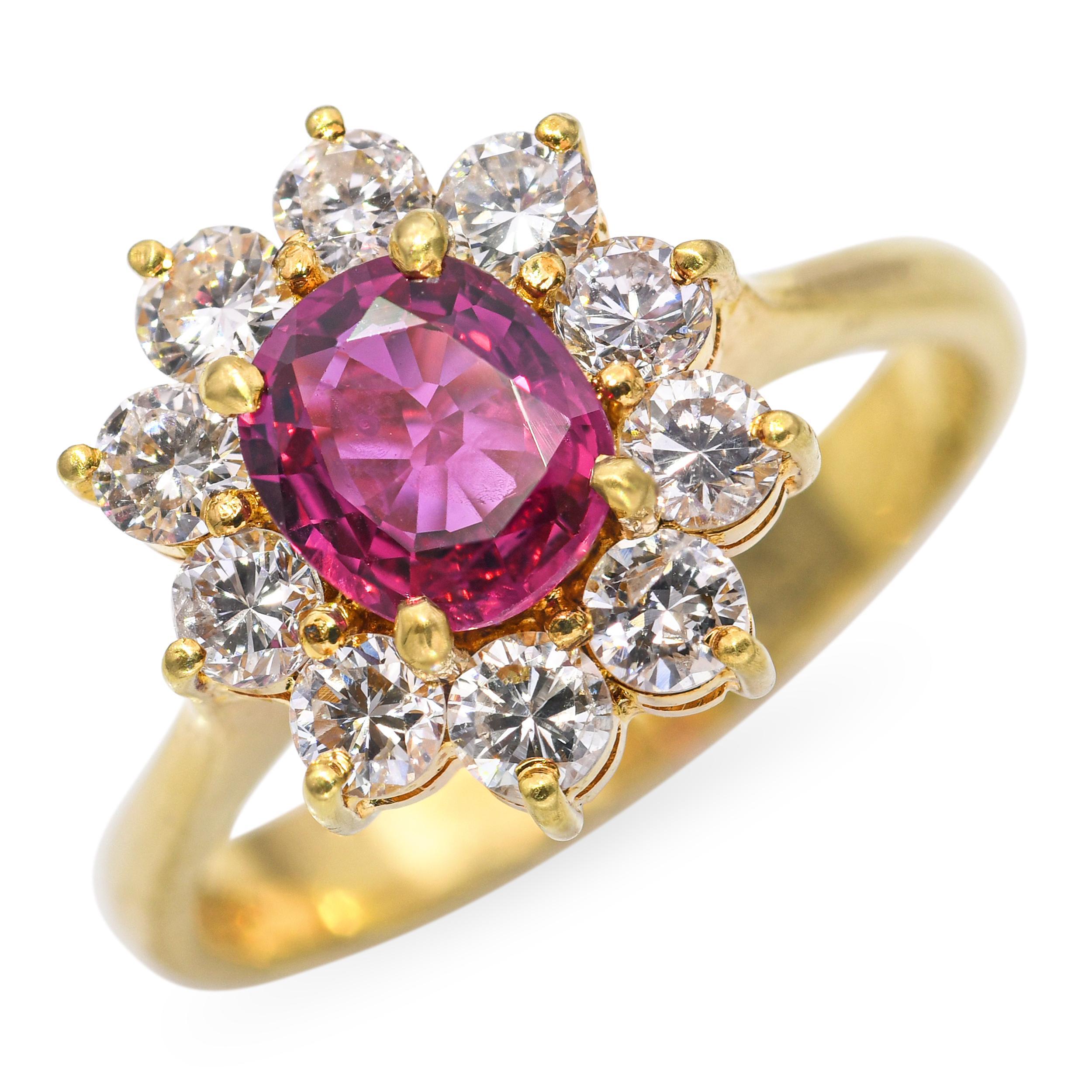 Questo anello vintage senza tempo è realizzato in oro giallo 18 carati e ha come centro un rubino dalle tonalità intense. Il rubino è circondato da una scintillante aureola di diamanti brillanti, che esaltano il vibrante colore rosso della gemma.