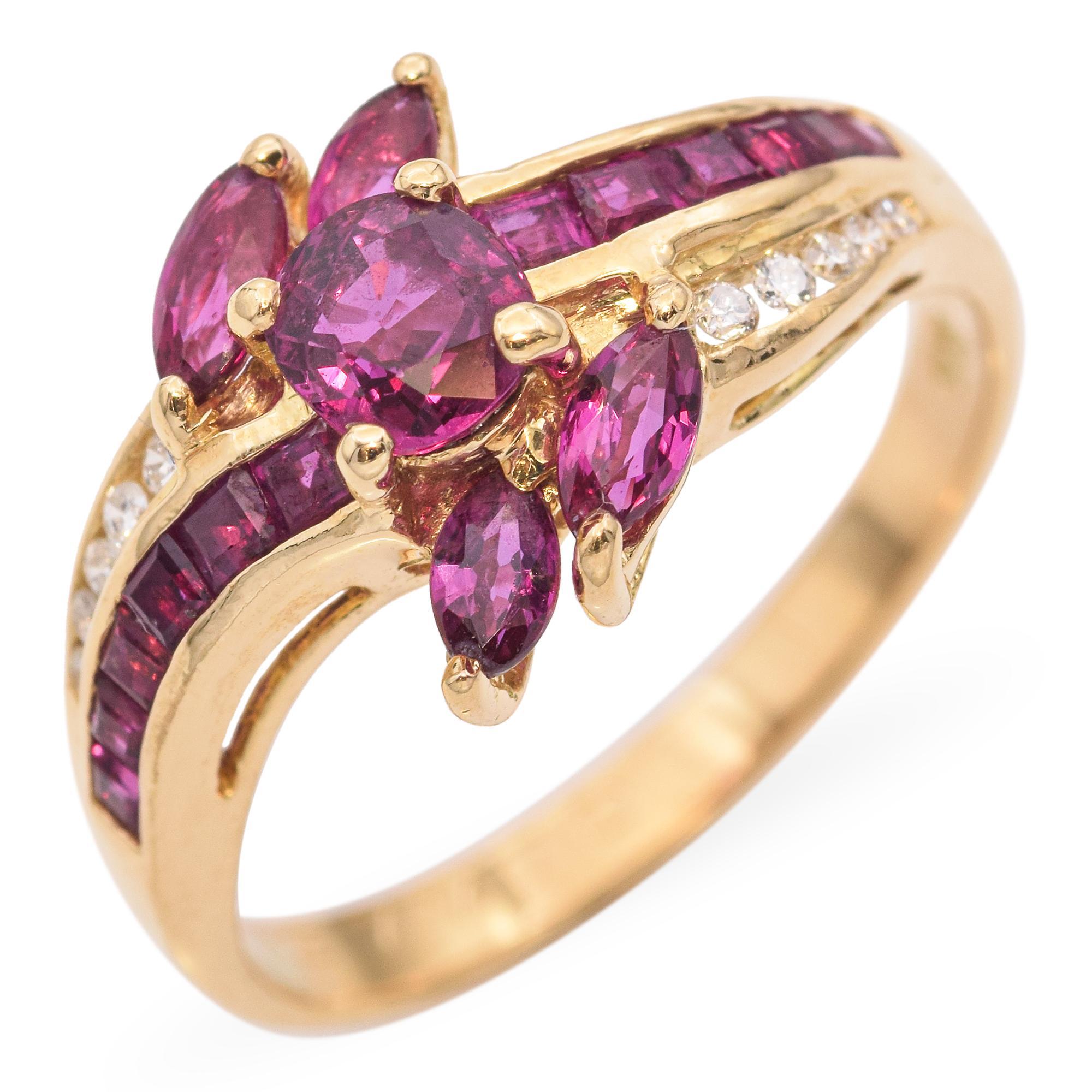 This vintage swirl ring is crafted from rich 18k yellow gold and features a captivating design that wraps elegantly around the finger. A vibrant ruby sits at the center, accented by a series of sparkling white diamonds that follow the graceful