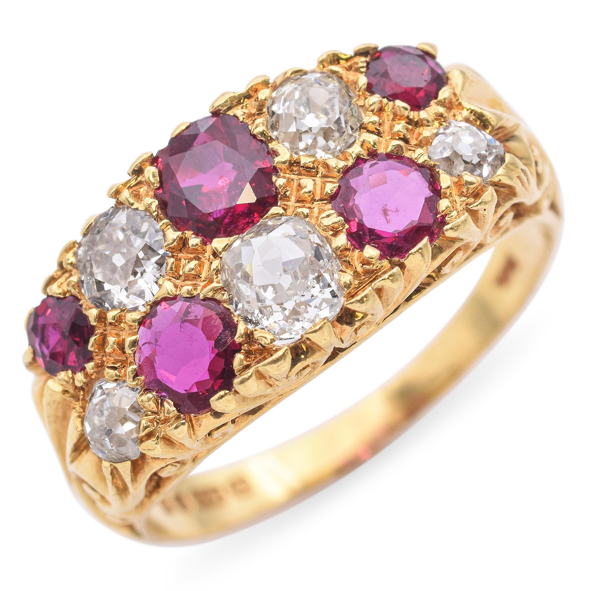 This vintage antique ring features a rich arrangement of rubies and old mine cut diamonds, set in a deeply textured 18k yellow gold band. The alternating gemstones create a bold, eye-catching pattern with beautiful contrast between the vibrant red