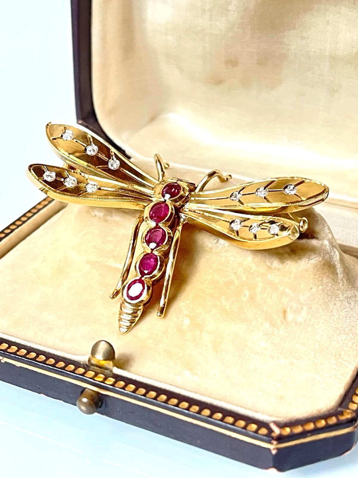 Fashionable vintage 18K yellow gold, ruby and diamond dragonfly brooch. Colourful, embellished with 6 natural, non-treated bright violet red rubies, this brooch is very well made, large in size and looks extremely stylish when worn. 

Item
