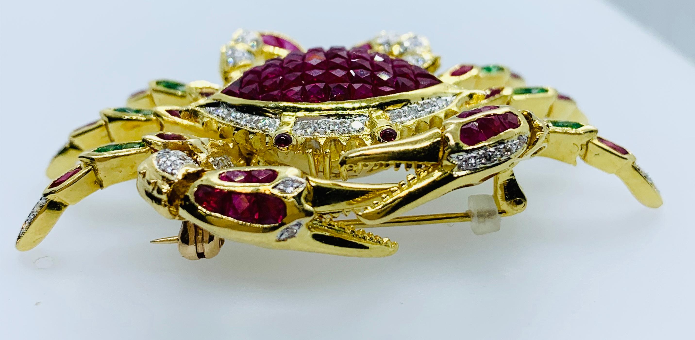 Stunning Crab Brooch! This piece is made in 18K yellow Gold this piece features French Cut Rubies and Diamonds for the crab's body, ruby eyes, ruby, diamond and emerald legs and ruby and diamond pinchers! This piece is so shiny and bright.... the