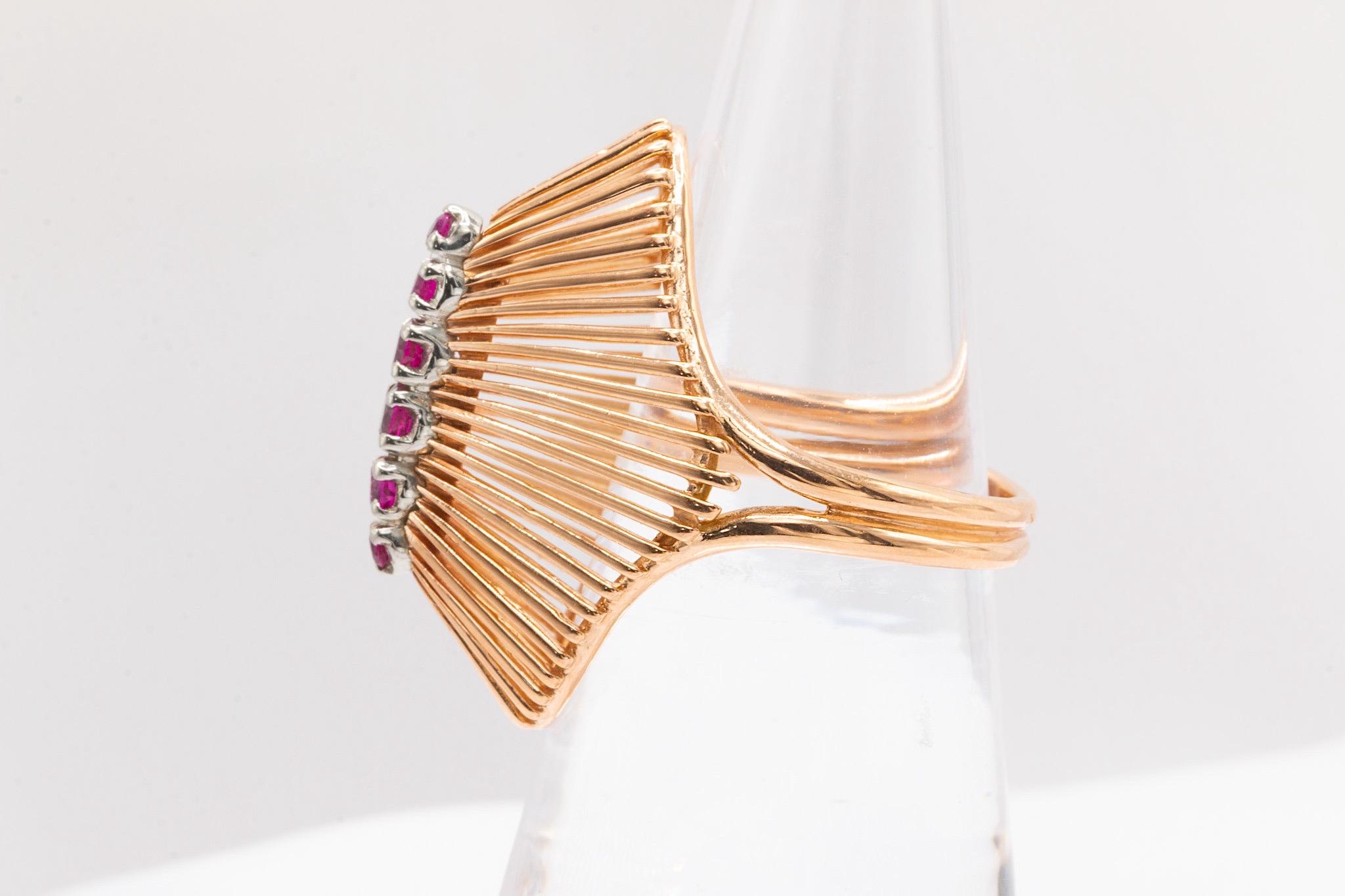 This striking vintage ruby ring is crafted in 18k yellow gold and showcases a distinctive design. Featuring 6 vibrant rubies, it offers a bold and elegant touch. The ring weighs 7 grams and is a size 6, with the option to resize. As a vintage piece,