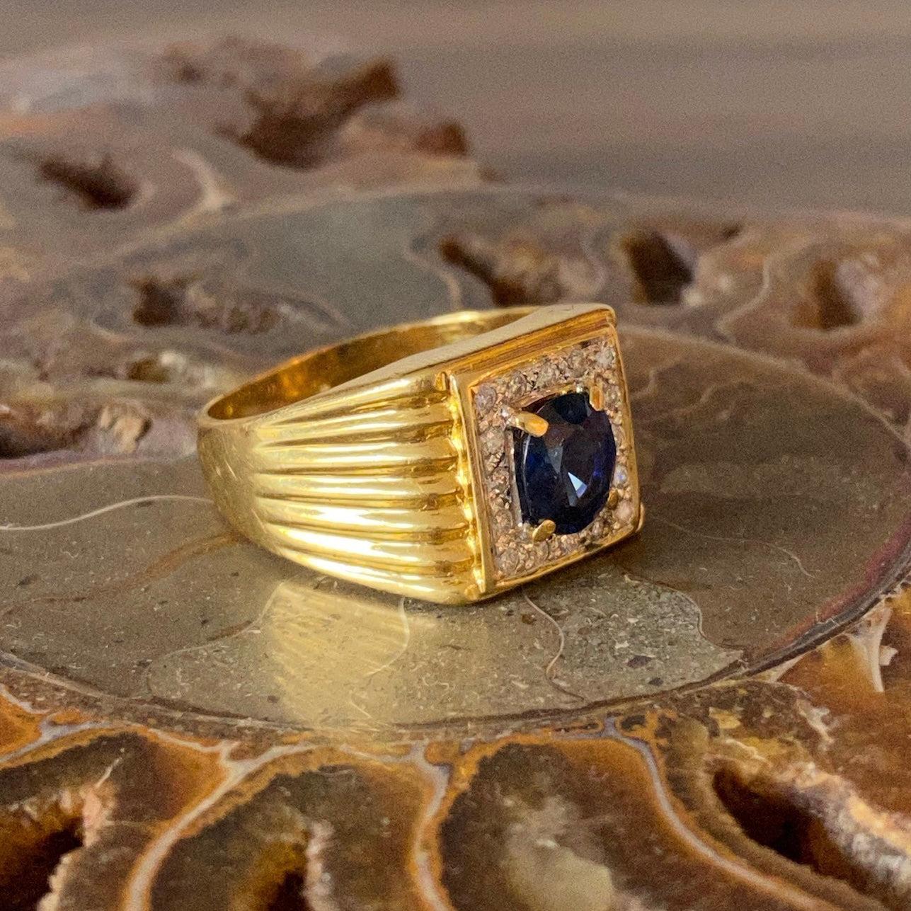 Crafted in 18K yellow gold, the ring features an oval cut blue sapphire framed by diamonds and supported by tapering fluted shoulders.
1 sapphire: 1.25ct.
16 round brilliant cut diamonds: 0.16 ctw. Color: G-H, Clarity: SI2-I1
Measurements:
Front: 13