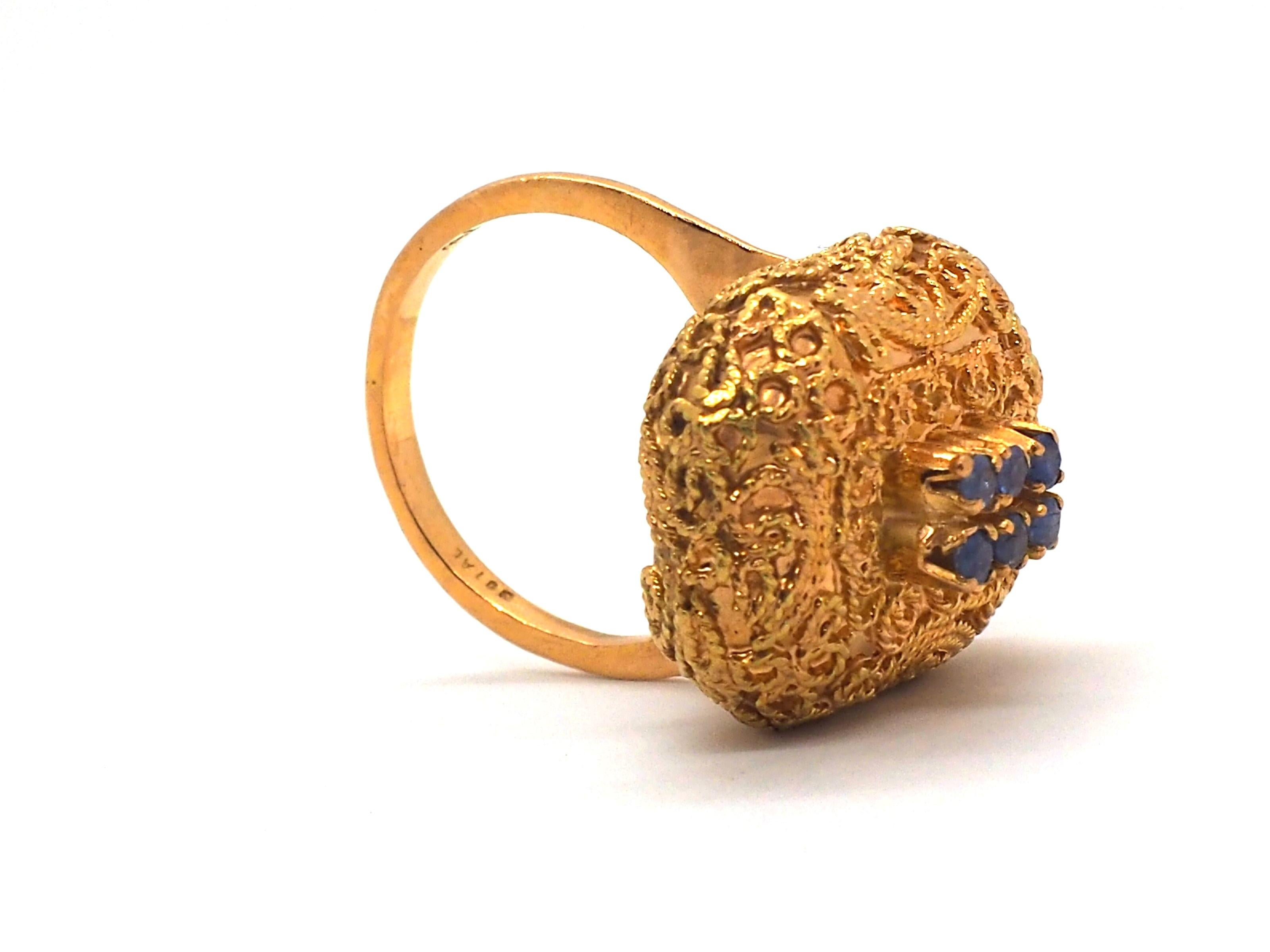 A vintage ring made of 18k yellow gold is a unique exclusive  piece of jewelry. The warm tone of the yellow gold gives the ring a timeless and elegant appeal.

The ring is adorned with six small sapphires, which add a touch of color and sparkle.
