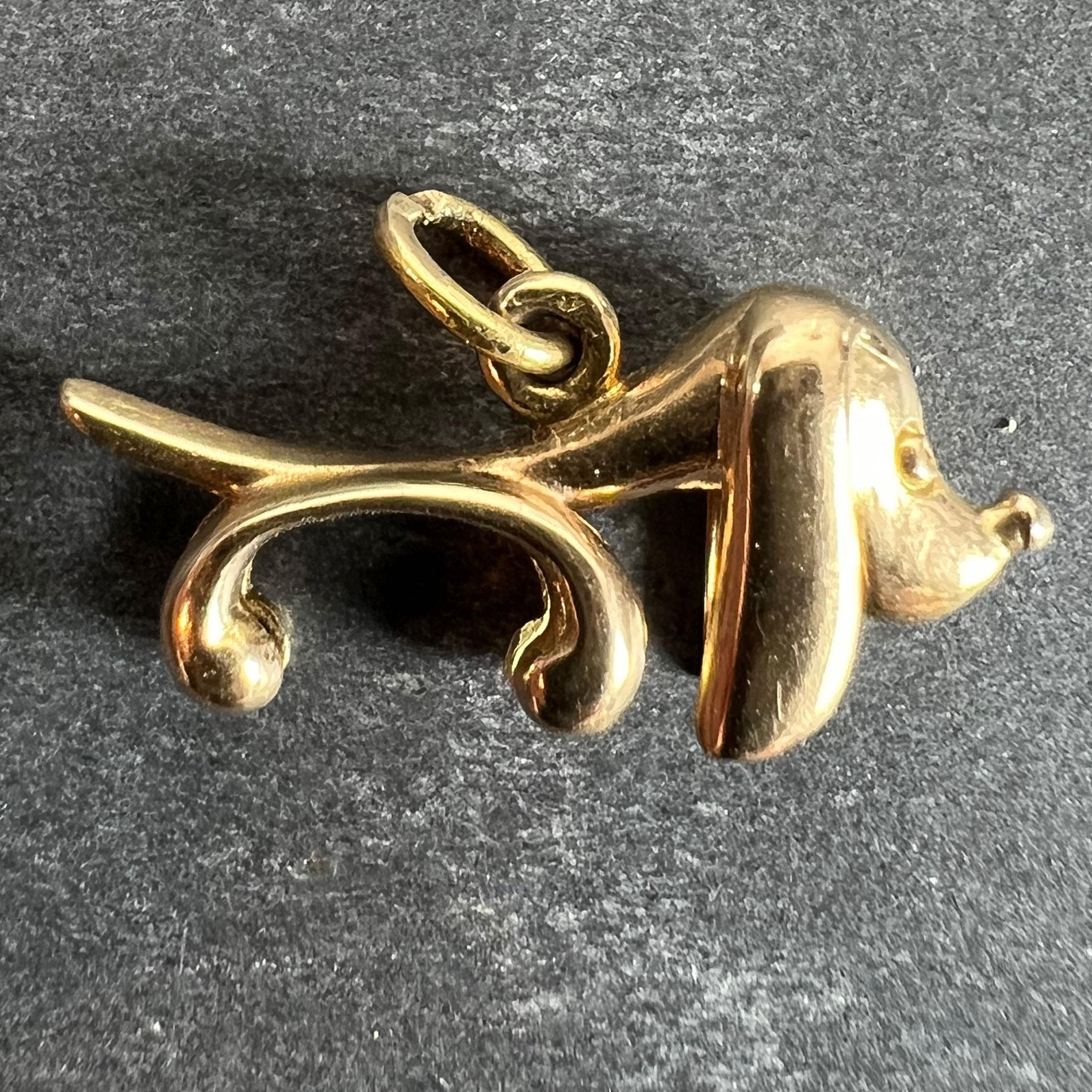 An 18 karat (18K) yellow gold charm pendant designed as a sausage dog or Dachshund with elongated body and ears. Unmarked but tested as 18 karat gold.

Dimensions: 2.2 x 1 x 0.6 cm (not including jump ring)
Weight: 2.33 grams
(Chain not included)