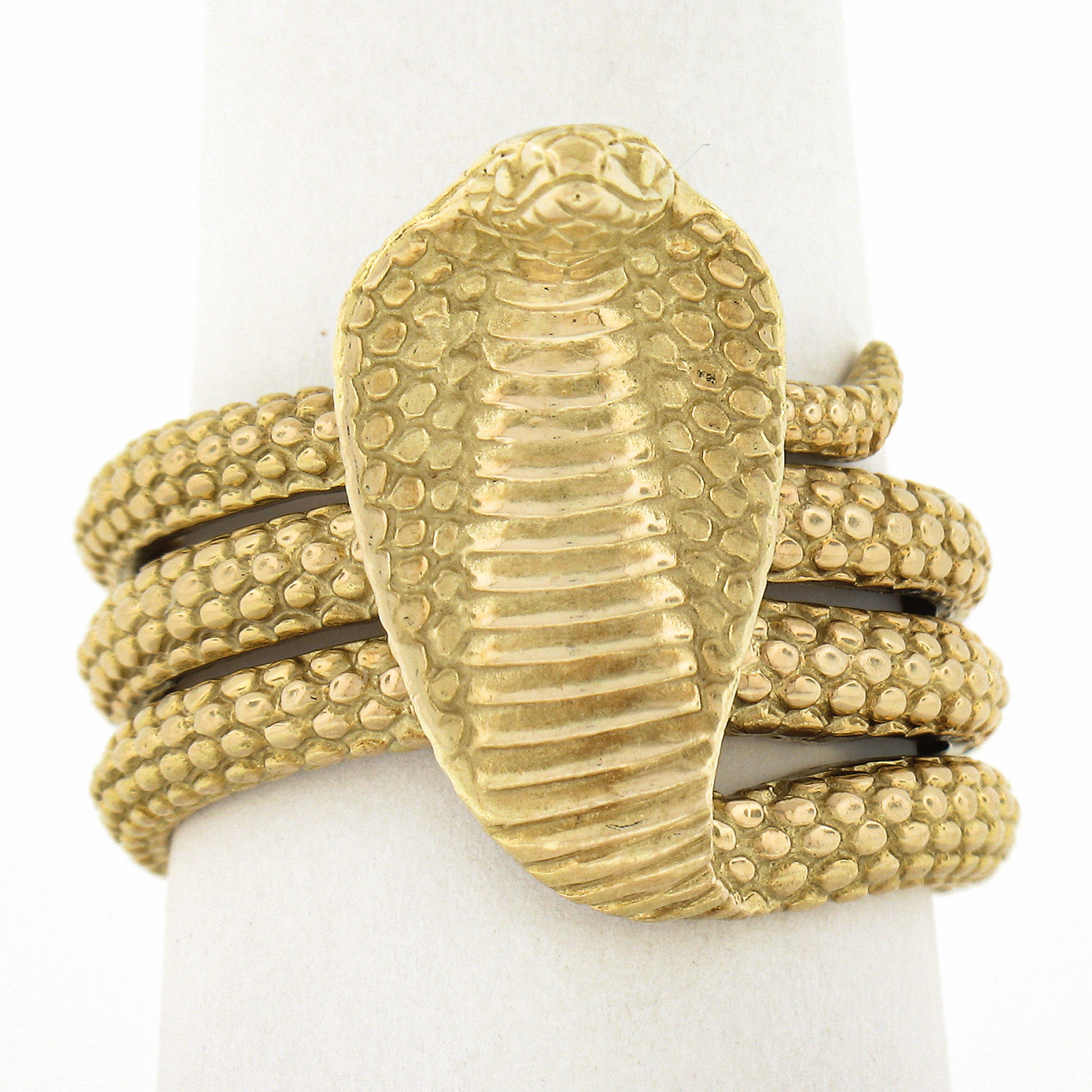 Here we have an one of the most incredible snake rings we have EVER seen. It is a cobra snake band ring crafted from solid 18k yellow gold and features a nicely high detailed textured coiled snake design with the cobra snake head and tail elegantly