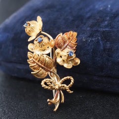 Tiffany & Co Broche fleur vintage en or jaune 18 carats avec saphirs