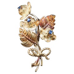 Broche flor vintage Tiffany & Co. de oro amarillo de 18 quilates con zafiros