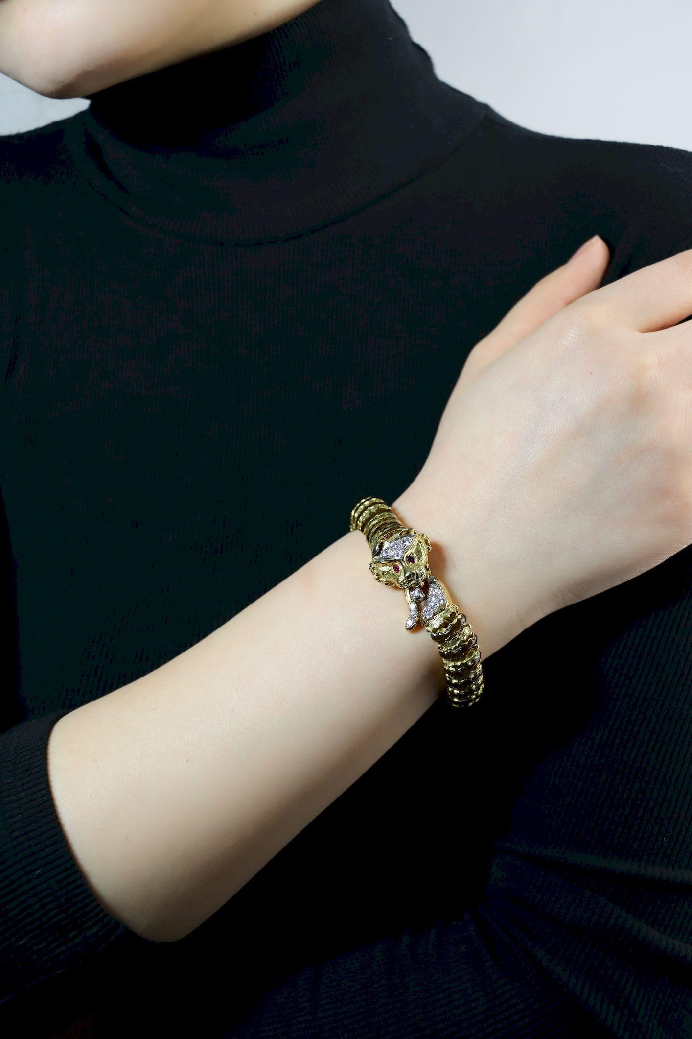 Vintage 18K Yellow Gold Tiger Bracelet

Marked:
18K

Approximate Dimensions:
17.5 (Length) 
0.9 - 1.7 cm (Width)
Approx. 0.89 carat (Diamond)
72.3 grams in weight.