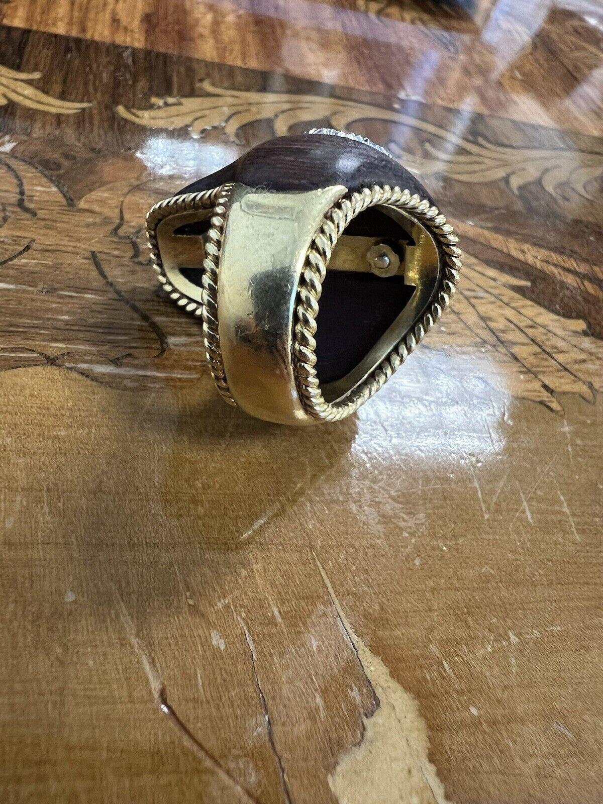 Vintage 1970s 18k Yellow Gold, Diamond, Wood & Ruby Cocktail Ring 

Here is your chance to purchase a beautiful and highly collectible designer cocktail ring. Truly a great piece at a great price! 

Details:

Add a touch of vintage elegance to your