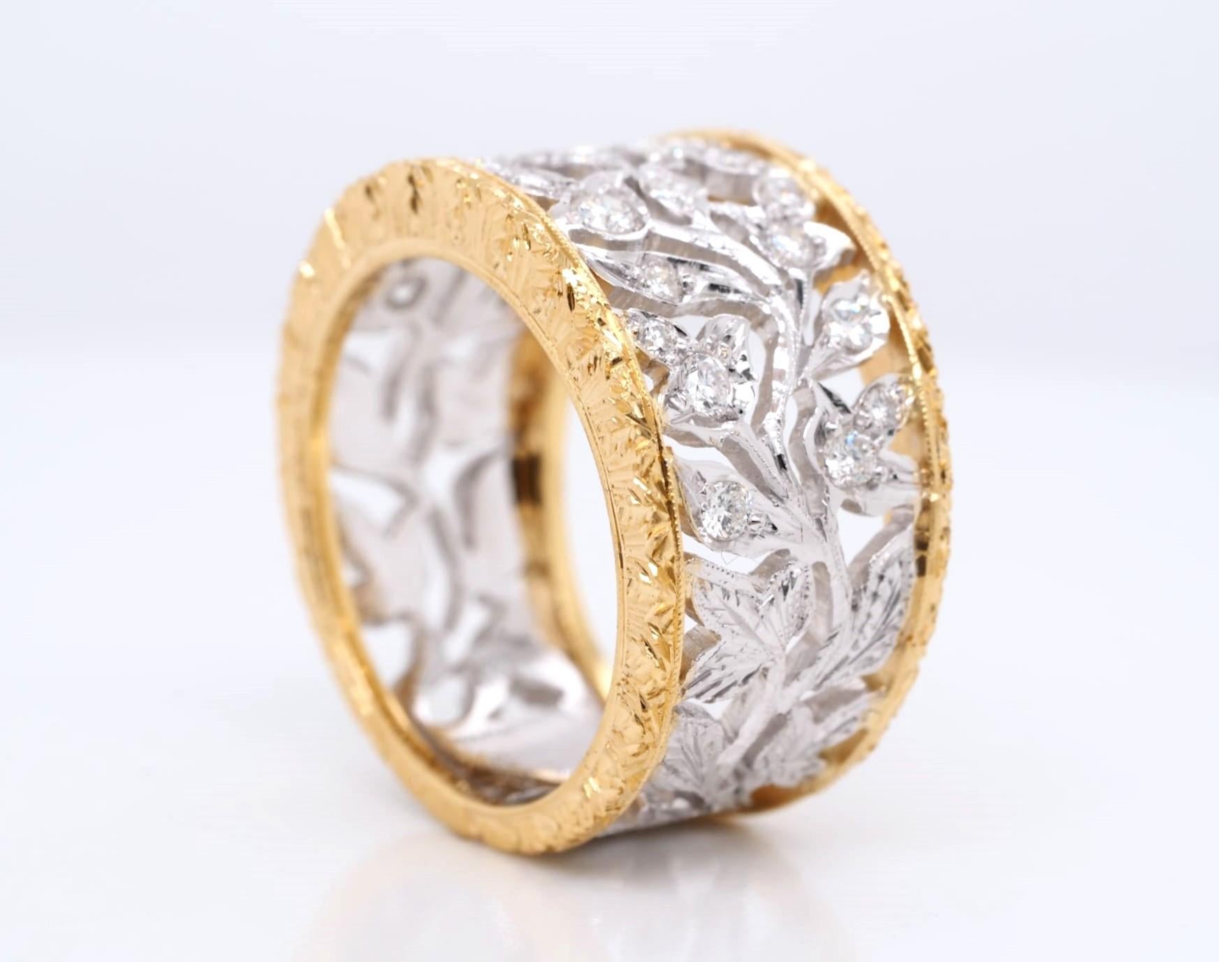 This beautiful vintage 18K yellow and white gold band ring features 24 round cut diamonds with a total carat weight of 0.60 ct. The diamonds are set in a prong setting style and are graded as very slightly included (VS1) in clarity and G in color