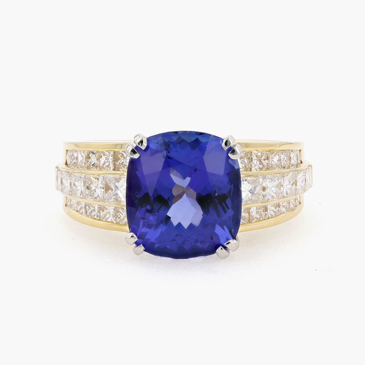 Platinum and 18K Yellow Gold Tanzanite and Diamond ring. This ring features a cushion cut Tanzanite stone weighing 6.35 carats and 32 princess cut diamonds weighing 2.06 carats.  F-G in color VVS in clarity. Ring is size 10. 

Though commonly