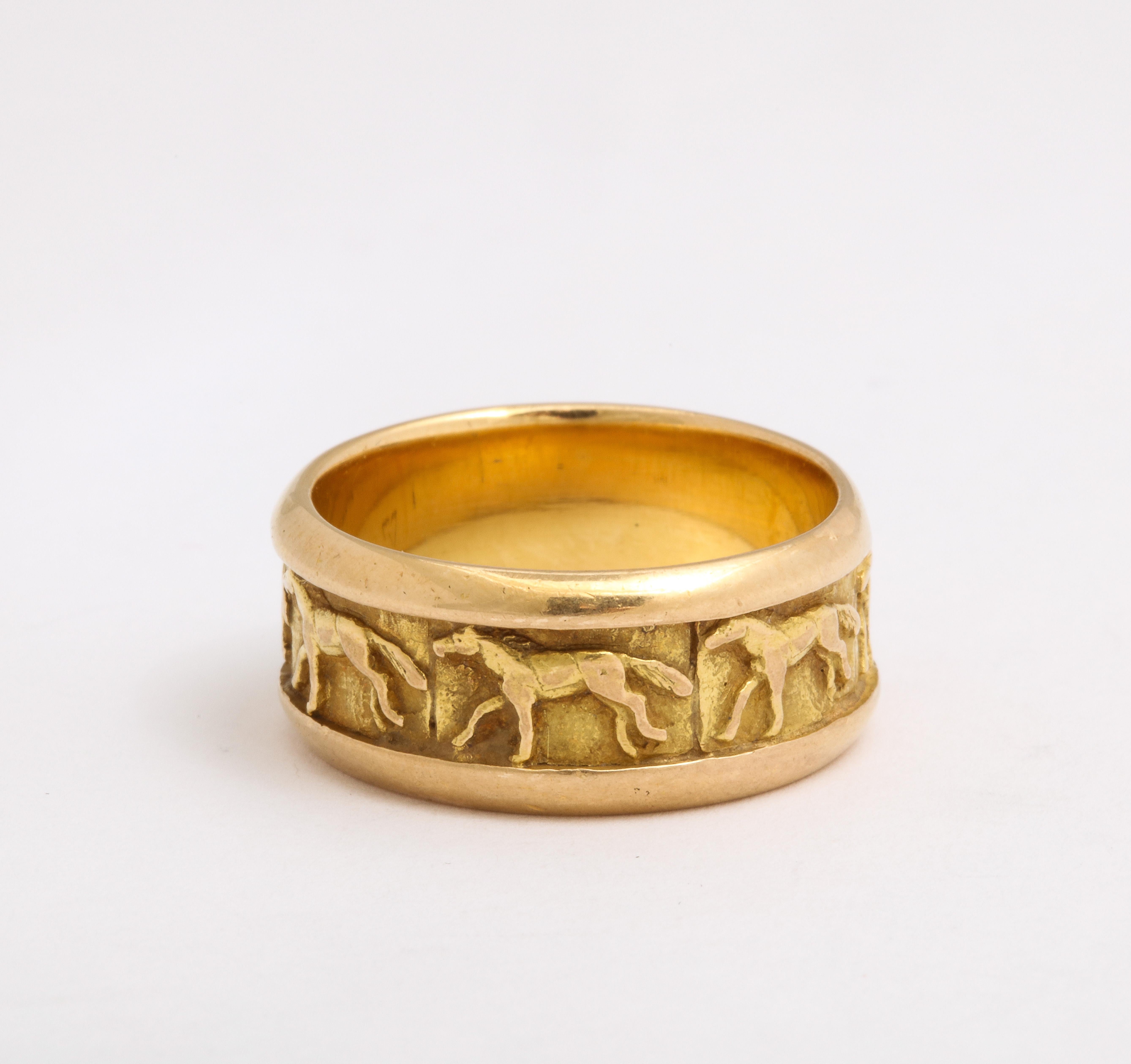 Design enthusiasts and equestrian devotees and animal lovers will appreciate this 18 kt gold chunky band with horses racing around its circumfrence.  The horses are raised from the background. The method of construction is unique. It is made in
