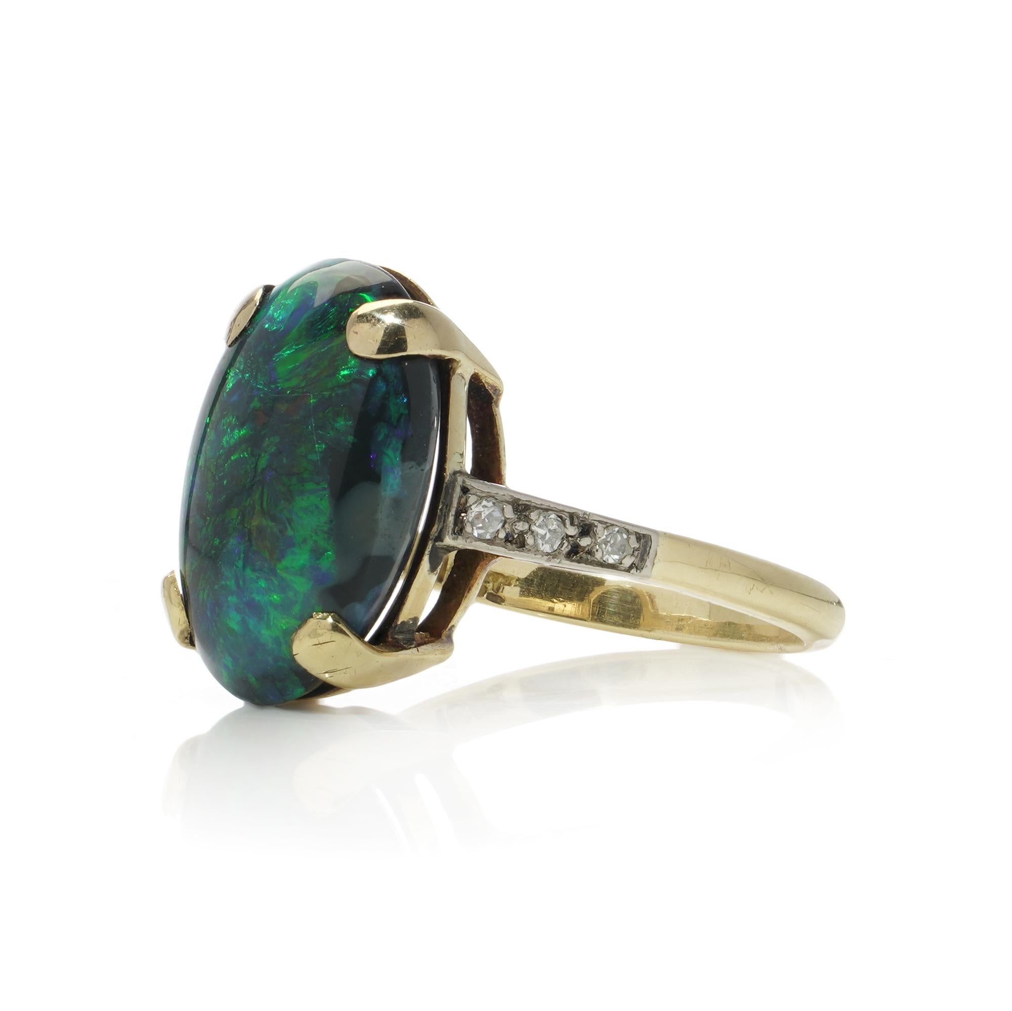Oval Cut Vintage 18kt gold black opal and diamond ring. For Sale