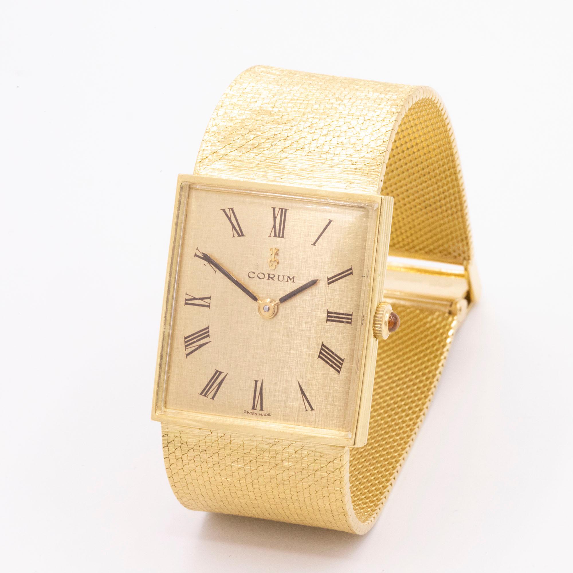 Vintage 18kt Yellow Gold Corum. The movement is mechanical and this timepiece is manually wound. The case is square and has a beautiful champagne roman numeral dial. The gold mesh bracelet has a signature Corum clasp. Hallmarked numbers 57165 &