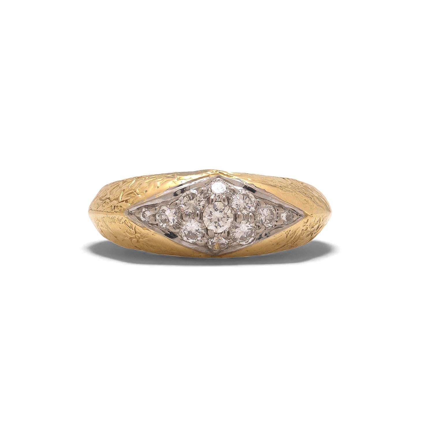 A vintage 18kt yellow gold diamond ring by Kutchinsky, dating from the 1970s and showcasing the maker’s signature bold, sculptural goldwork. The ring features a tapered panel of graduated round brilliant cut diamonds in a white gold setting,