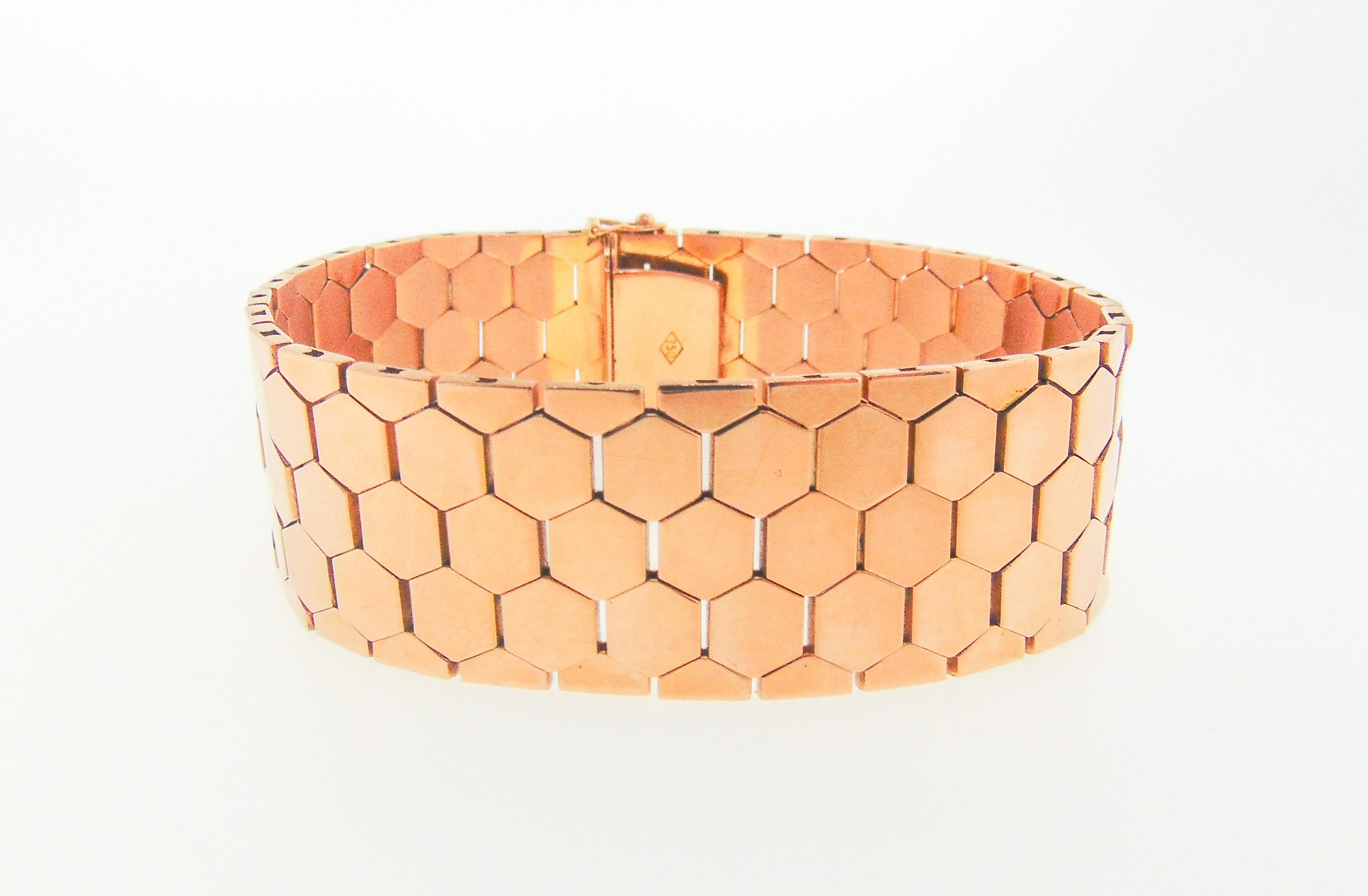 Luxuriously smooth and easy to wear 18 karat rose gold bracelet composed of highly flexible hexagon shape links. The bracelet measures 7.75 inches in length (can be shortened) by .75 inches in width, weighs 46 gross pennyweights, and features a