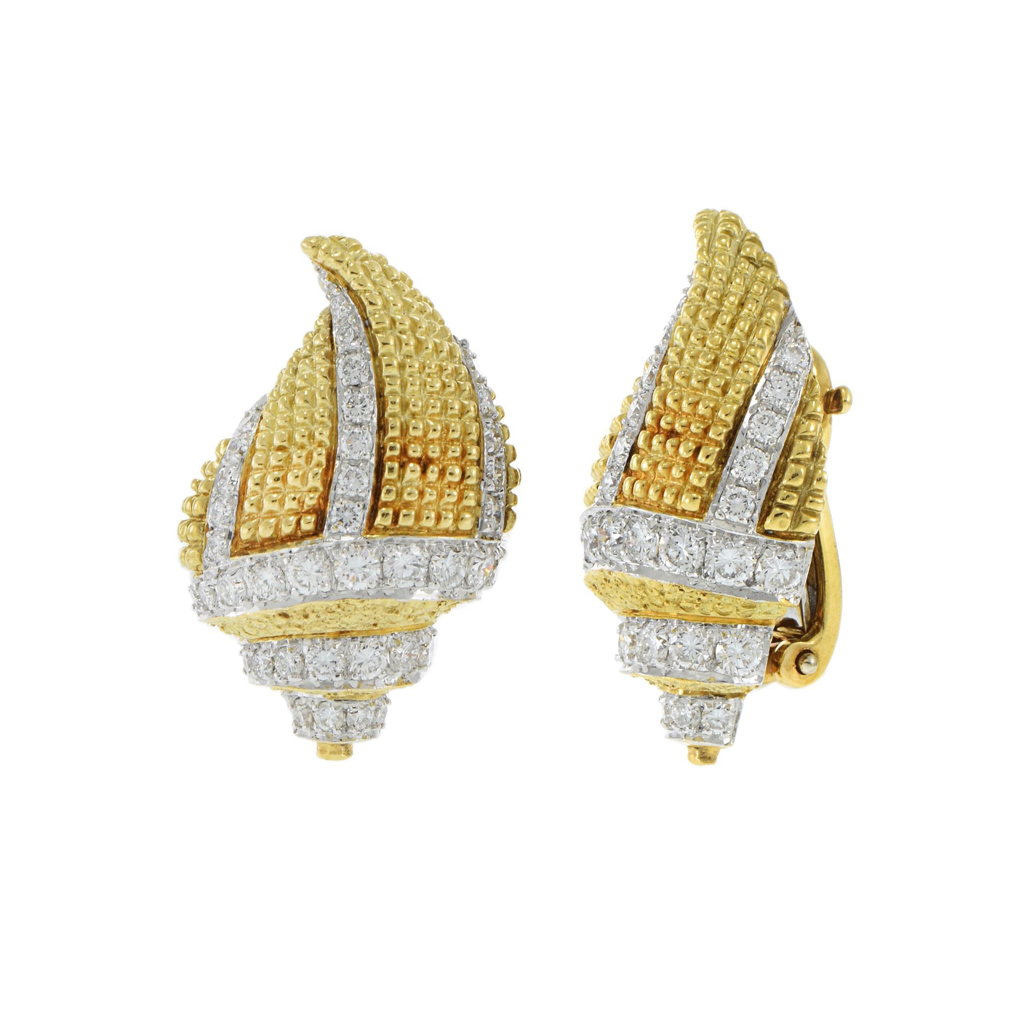A striking pair of vintage 1960s conch shell-inspired clip earrings, crafted in 18KT two-tone gold, combining rich yellow and white gold for a bold contrast. These intricately designed earrings are set with 2.50CT-TW of F-VS round-cut diamonds,