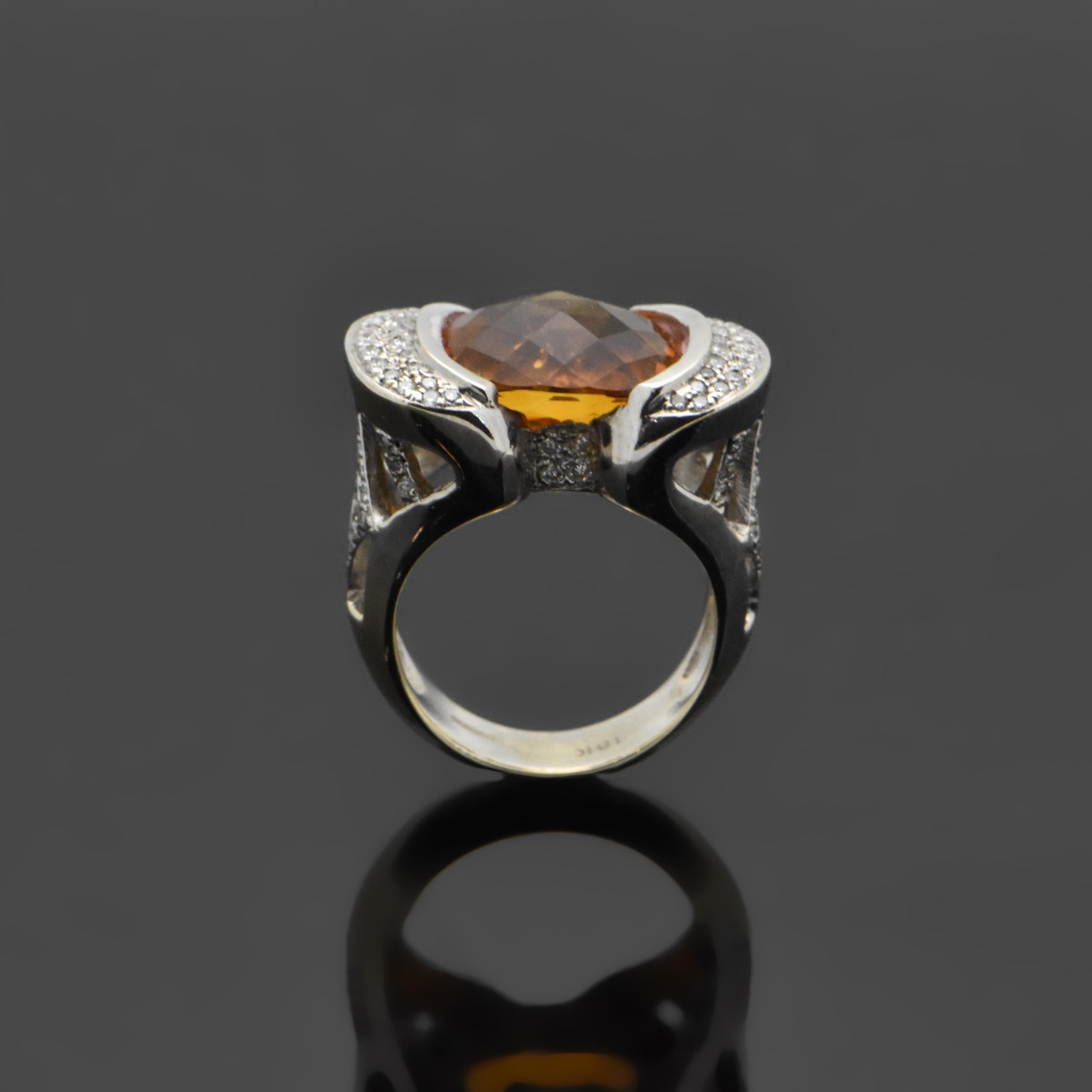 A vintage 18kt white gold ring featuring a large oval-cut citrine with an estimated weight of 3.53ct. highlighted with diamonds at an estimated 0.60 cttw. Estimated weight of gold is 8 gr. 

We will size it for you.

