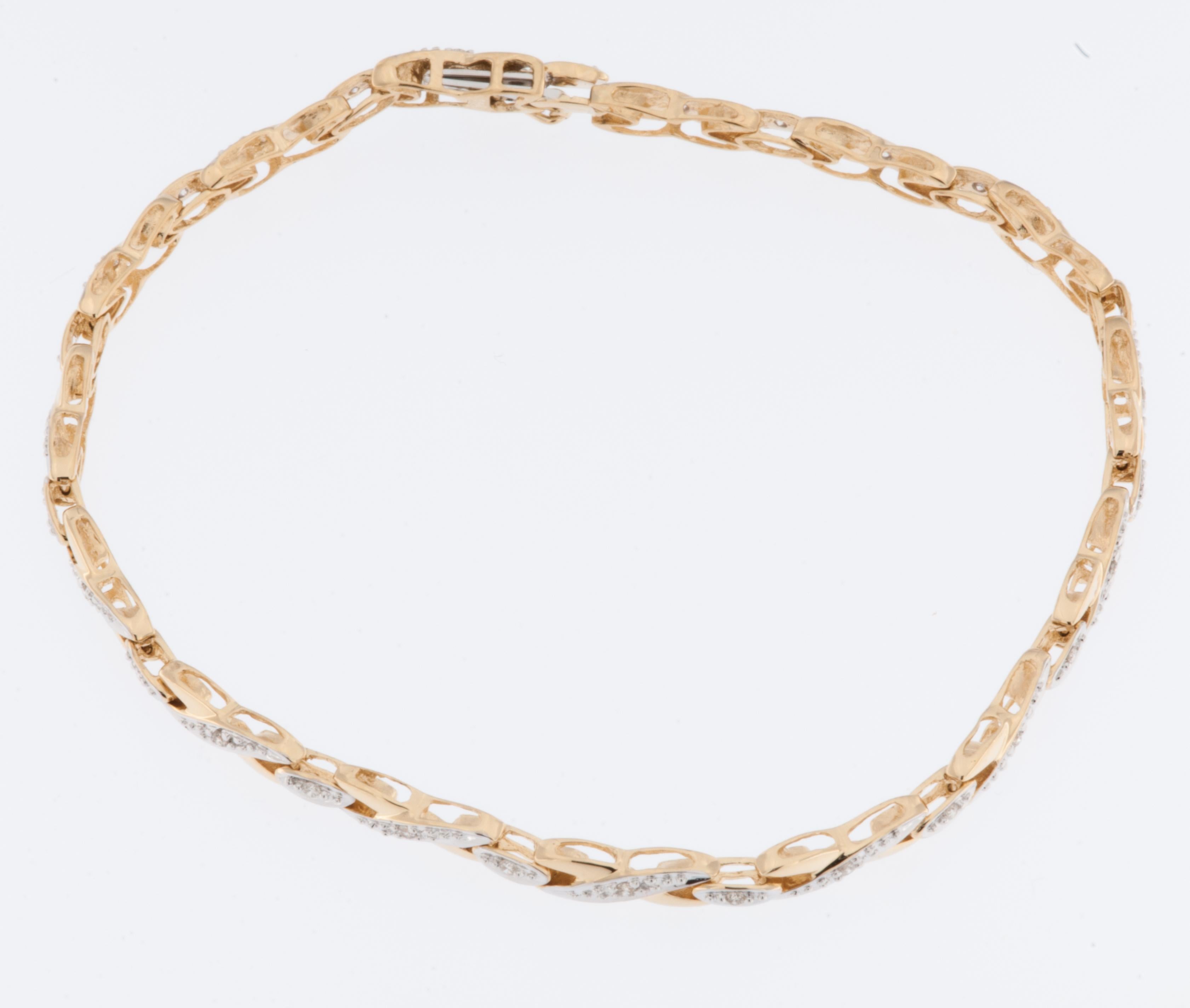 The vintage 18kt Yellow and White Gold French Bracelet with Diamonds is a beautiful piece of jewelry that combines yellow and white gold with the added elegance of diamonds. 

The bracelet is made of 18-karat gold, which signifies a high level of
